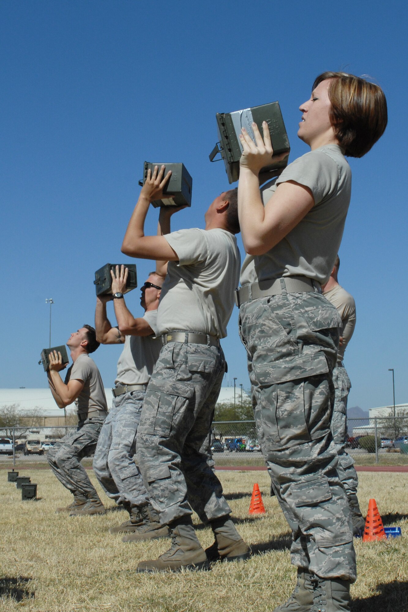 U.S. Air Force members lift boxes of ammunition at the Benko Fitness Center track on Davis-Monthan Air Force Base, Ariz., March 23.The Airmen participated in the Marine Challenge, which requires contestants to complete the U.S. Marine Corps Maneuver Under Fire course. (U.S. Air Force photo by Airman 1st Class Saphfire Cook/Released)
