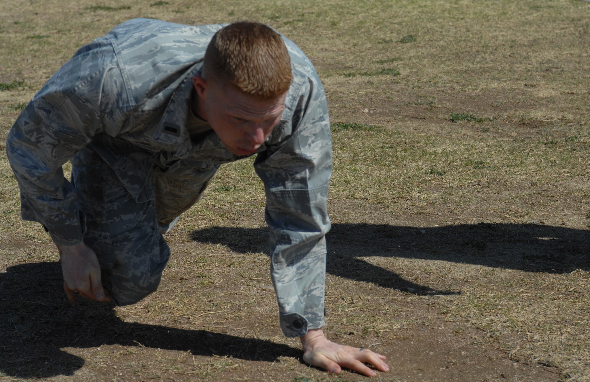 U.S. Air Force 1st Lt. Richard Landsverk, 25th Operational Weather Squadron, high crawls during the Marine Challenge at the Benko Fitness Center track on Davis-Monthan Air Force Base, Ariz., March 23. The high crawl was part of the obstacle course portion of the challenge.
