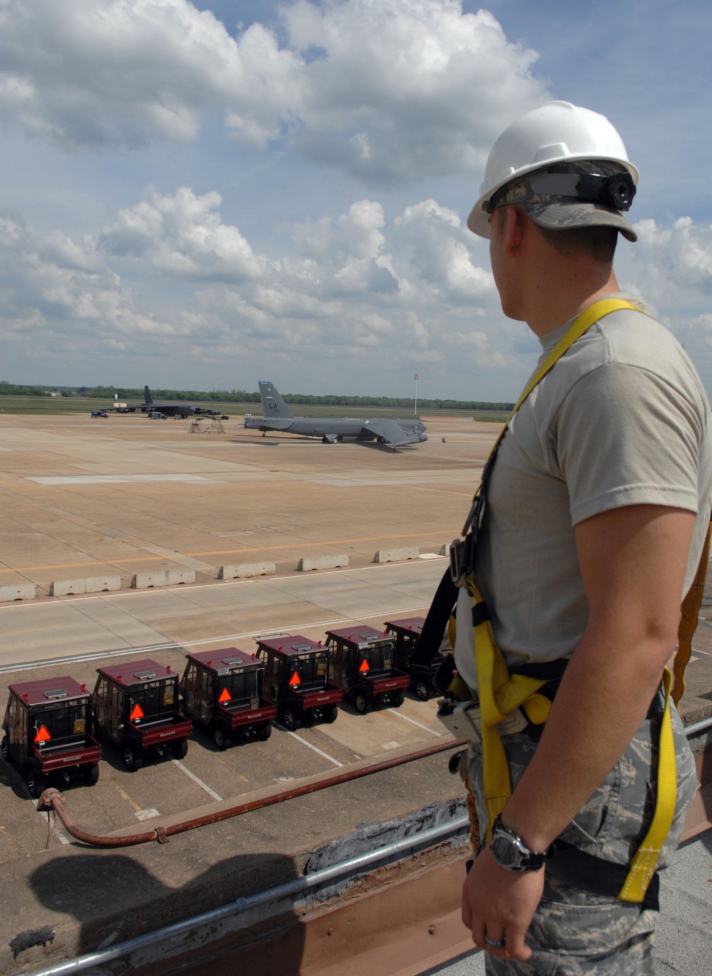 Senior Airman Steven Price, 2nd Civil Engineer Squadron structural apprentice, stands on the roof of the 20th Bomb Squadron on Barksdale Air Force Base, La., March 28. Price collected broken shingles that had gathered over the years to help with the flow of rain on the roof. (U.S. Air Force photo/Airman 1st Class Joseph A. Pagán Jr.)(RELEASED)