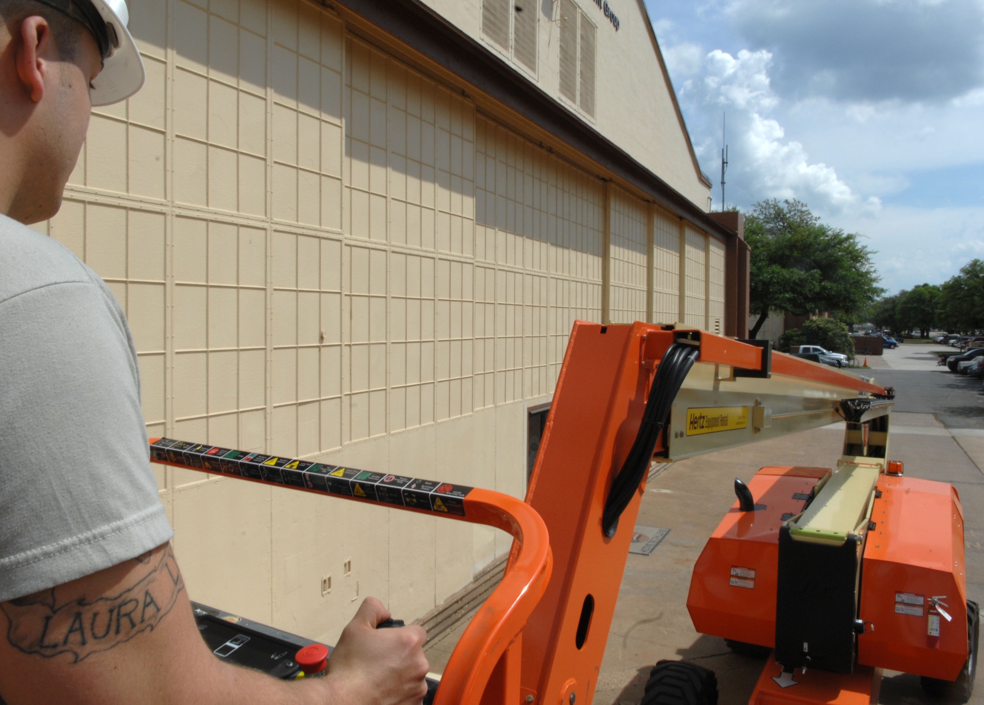 Senior Airman Steven Price, 2nd Civil Engineer Squadron structural apprentice, uses a Hertz boom lift to step on the roof of the 20th Bomb Squadron on Barksdale Air Force Base, La., March 28. Price is certified to use all of the machines that would be necessary to complete the job he is tasked . (U.S. Air Force photo/Airman 1st Class Joseph A. Pagán Jr.)(RELEASED)