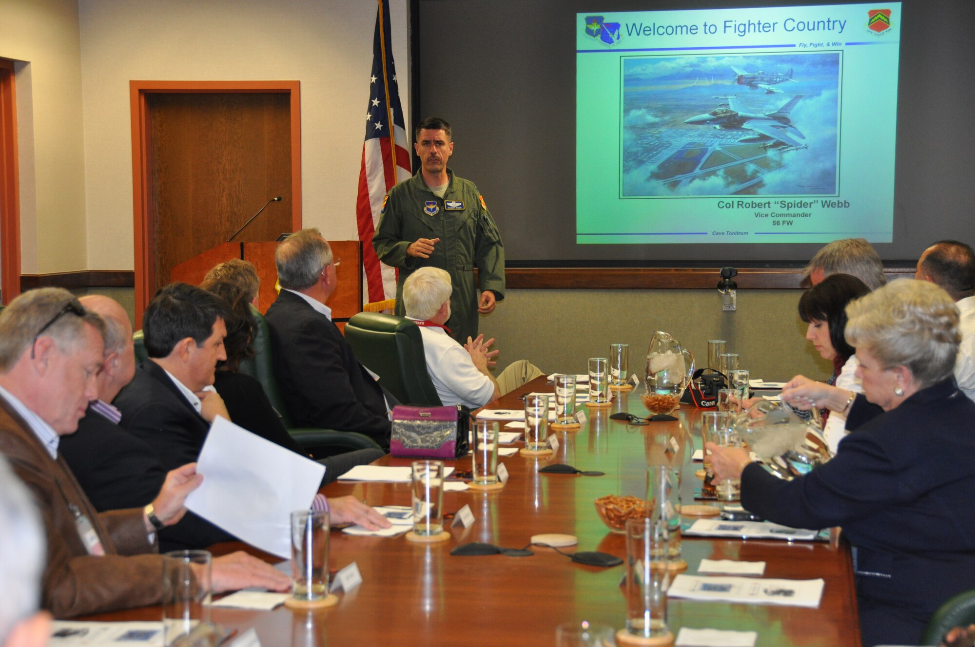 San Antonio civic leaders listen to a briefing by Col. Robert Web, 56th Fighter Wing vice commander during the 433rd Airlift Wing's recent civic leader tour to Luke Air Force Base, Ariz. on March 22.  A total of 17 San Antonio civic leaders also traveld to Davis Monthan AFB, Ariz.  Civic leaders flew in an F-16 simulator, met with other local civic leaders from the Phoenix and Tucson areas, visited the 305th Rescue Squadron pararescuemen and toured the Aerospace Maintenance and Regeneration Group, also known as "The Boneyard".  (U.S. Air Force Photo/ Tech. Sgt. Carlos Trevino)