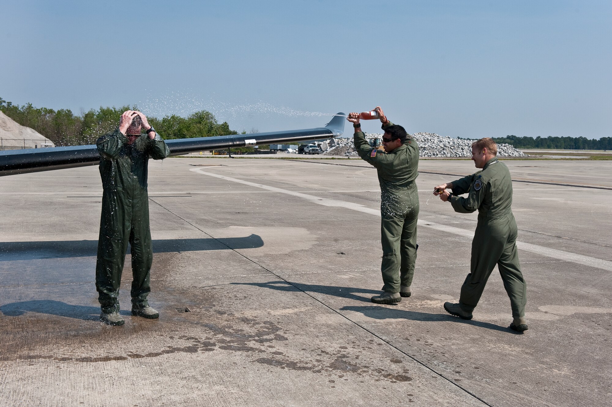 U.S. Air Force Lt. Col. Jeffrey P. Neely, director of operations at 319th Special Operations Squadron, gets sprayed down by champagne by two other members of the 319th SOS as part of a tradition during the final flight of a pilot at the flight line on Hurlburt Field, Fla., March 27, 2012. Neely led the squadron as an expeditionary squadron commander for six tours, overseeing more than 2,900 combat sorties and 15,900 combat hours all directly supporting special operations ground forces. (U.S. Air Force photo/Airman 1st Class Christopher Williams)(Released)
