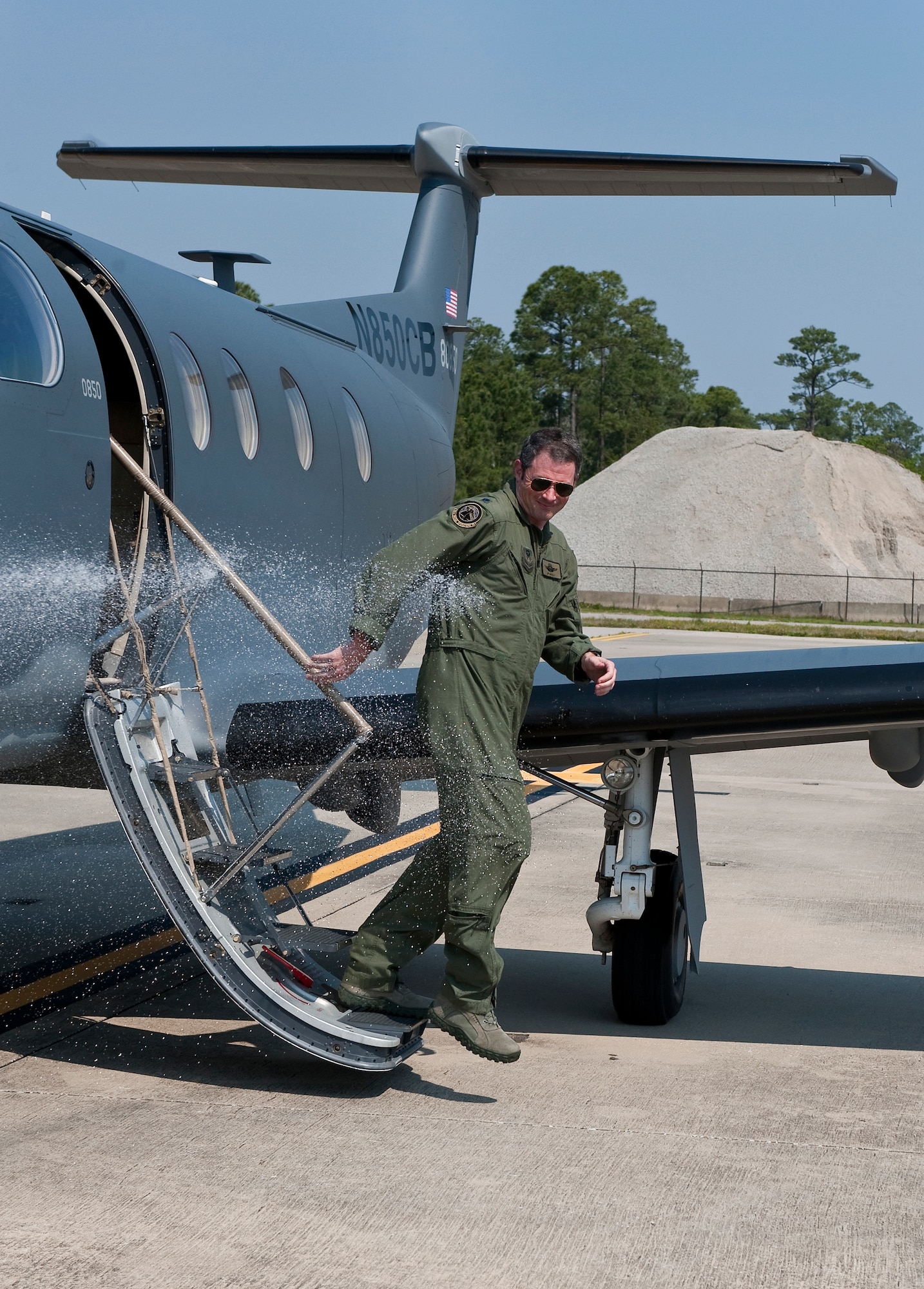U.S. Air Force Lt. Col. Jeffrey P. Neely, director of operations at 319th Special Operations Squadron, disembarks from a PC-12 for the last time while getting sprayed down by a fire hose at the flight line on Hurlburt Field, Fla., March 27, 2012. Neely has served as an evaluator pilot in the 319th SOS since the unit?s reactivation in 2006. (U.S. Air Force photo/Airman 1st Class Christopher Williams)(Released)
