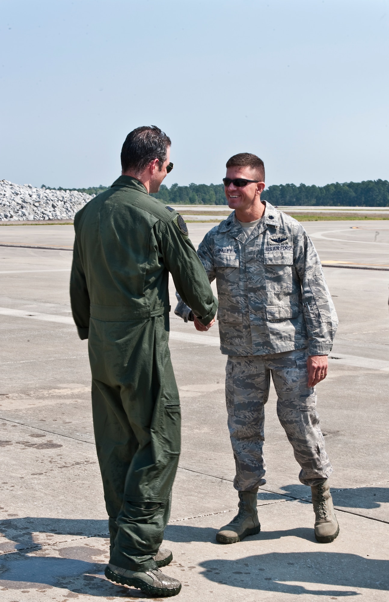 U.S. Air Force Lt. Col. Jeffrey P. Neely, director of operations at 319th Special Operations Squadron (Left), shakes hands with Lt. Col. Patrick Daley, commander of the 319th SOS, after Neely finished his final flight as an Air Force pilot at the flight line on Hurlburt Field, Fla., March 27, 2012. Neely had more than 3,200 total combat hours the most of any Air Force pilot to date. (U.S. Air Force photo/Airman 1st Class Christopher Williams)(Released)

