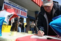 MINOT, N.D. – Earl Rogstad of Minot, signs his name into a log at the Veteran's Center in Minot, March 29, during the center’s first ever Vietnam Veterans Day Welcome Home celebration. Rogstad served 12 years in the United States Army and served 2 tours in Vietnam. The event was held as part of a Presidential Proclamation issued by the Commander in Chief proclaiming March 29 as a day of observance for Vietnam Veterans. The event also marked the 50 year anniversary of the Vietnam War and included various programs and activities for the attendees. (U.S. Air Force photo/Airman 1st Class Kristoffer Kaubisch) 