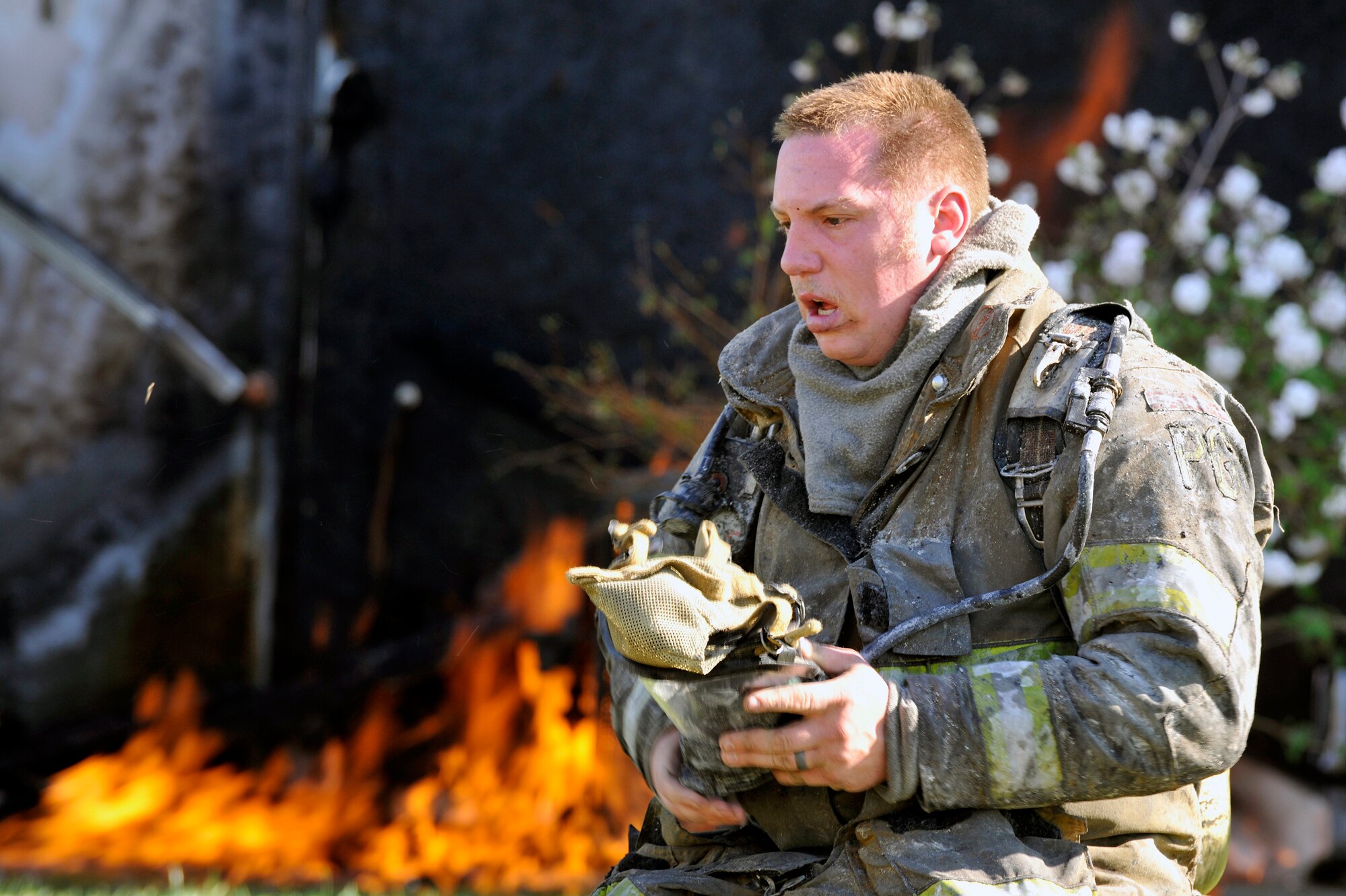 A Prince George’s County firefighter takes off his self-contained breathing mask after fighting a house fire here March 29. Firefighters from the 11 CES and two stations in Prince George's County fought the flames that damaged multiple surrounding homes. (U.S. Air Force photo/Senior Airman Perry Aston)