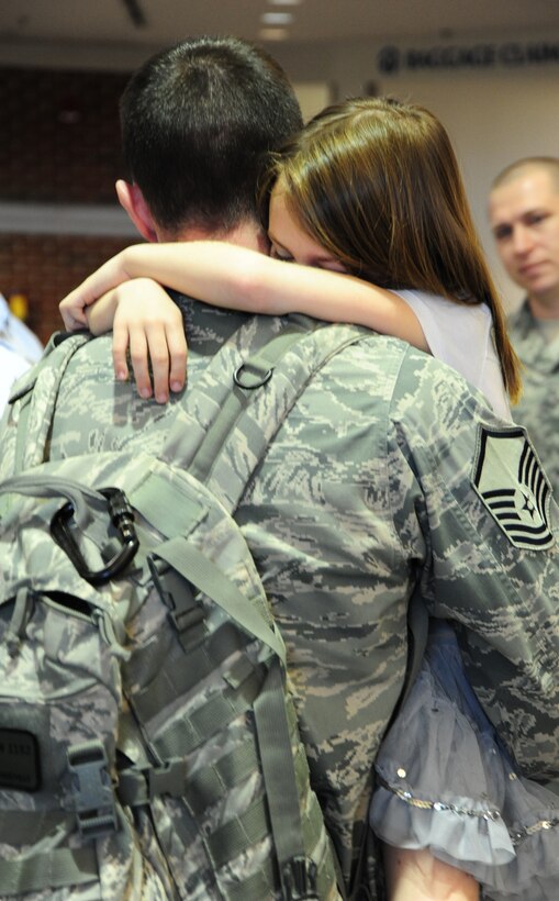 Master Sgt. Robby G. Kindernay, 42nd Security Forces Squadron, reunites with his children at Montgomery Regional Airport in March 2011. Kindernay, who was deployed for six months to Afghanistan, was greeted by his wife, Tech. Sgt. Jennifer Kindernay, and their two children, Ashlyn and Dalton. Programs at the Airman and Family Readiness Center help families of deployed military members, who face adjustments throughout the deployment cycle. (Air Force photo/Senior Airman Christopher S. Stoltz)