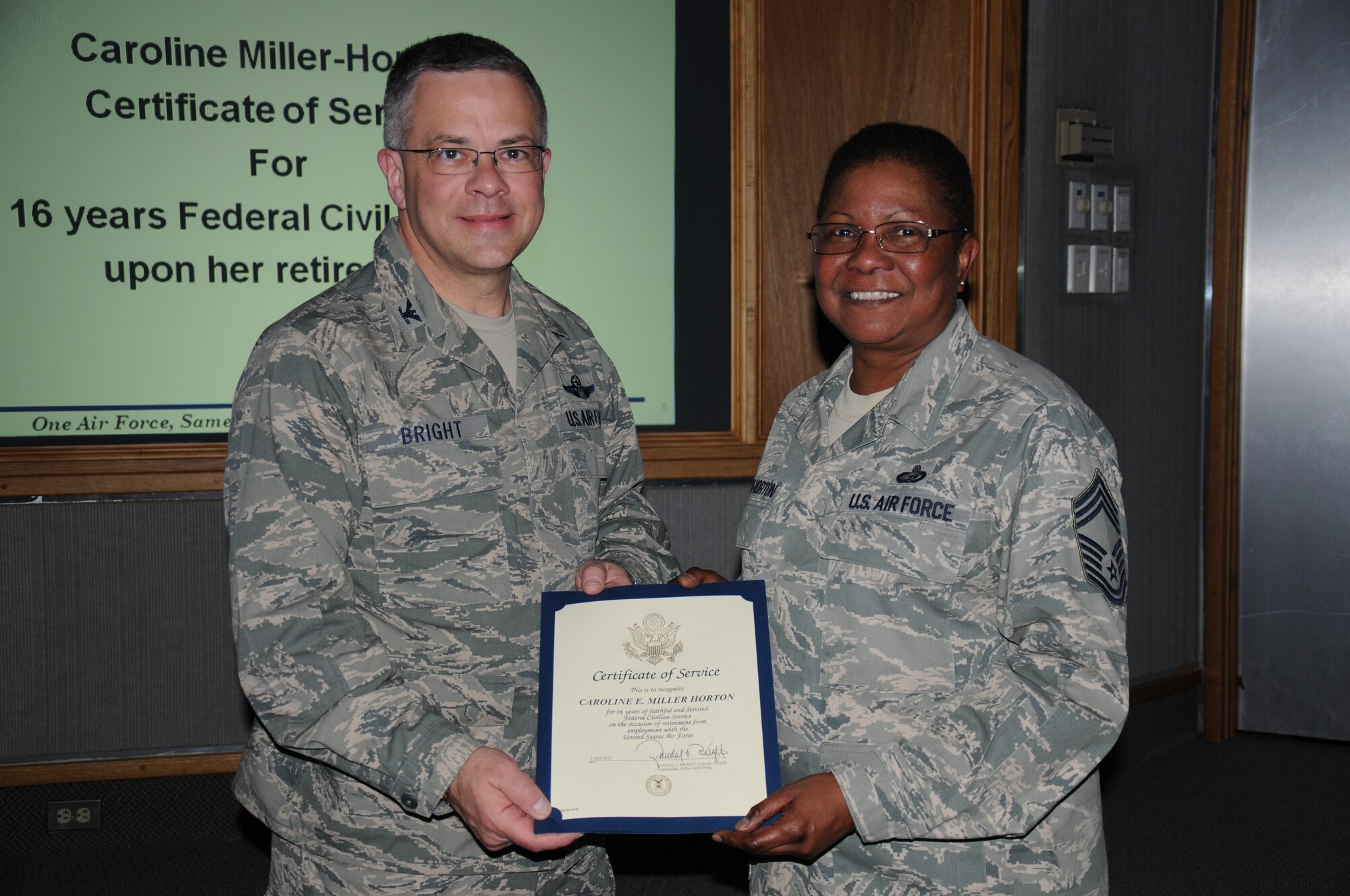 Col. Randal L. Bright, 512th Airlift Wing commander, presents Chief Master Sgt. Caroline E. Miller-Horton, 512th Force Support Squadron, with a pin and certificate in recognition of her 16 years of service to the Air Force upon her retirement scheduled for April 4, 2012. Miller-Horton is an Air Reserve Technician. She works as civil service employee during the week in the same job she holds as a reservist on unit training assembly weekends. ARTs are the full-time backbone of the unit training program, providing day-to-day leadership, administrative and logistical support, and operational continuity for their units. More than 15 percent of all reservists are ARTs. (U.S. Air Force photo by Capt. Marnee A.C. Losurdo)