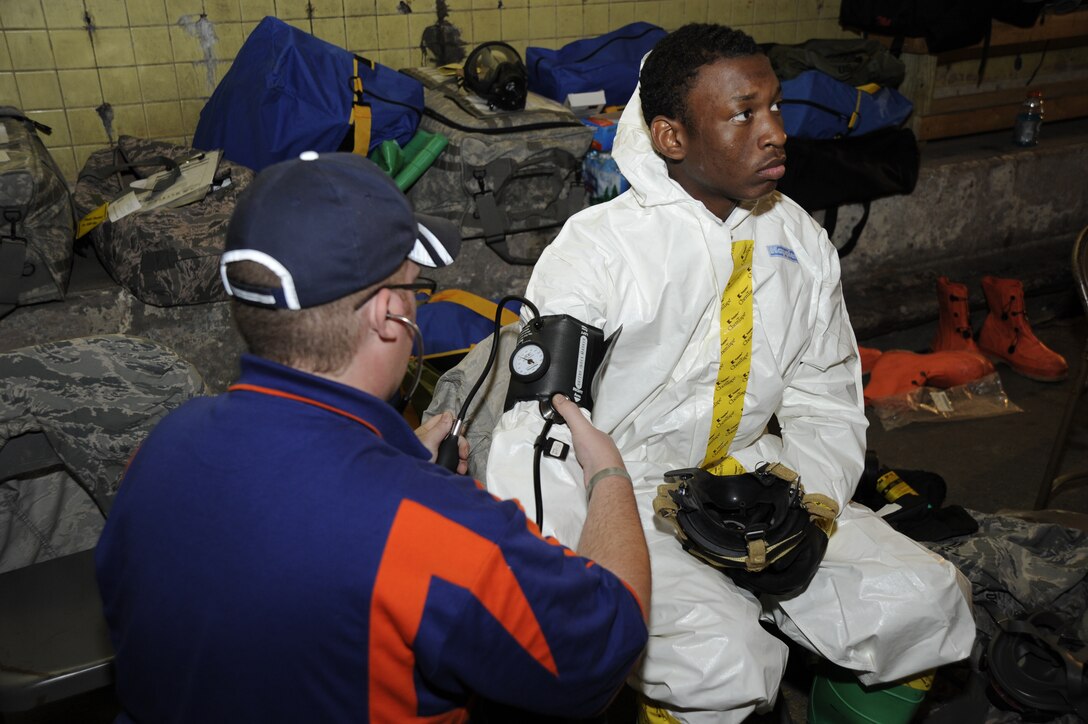 Aeromedical Squadron Bioenvironmental engineering technician Airman 1st Class Tony Pauline gets his vitals checked by Will Hensley, Alert 1 Emergency Medical Services, Paint Creek, W. Va. March 28 during the Air Force District of Washington Black Flag Exercise held at the Center for National Response in Gallagher W.Va. The training provides a real-world environment where players simulate emergency and disaster scenarios involving checking vitals before donning personal protective equipment, reading results from radiological equipment and saving lives in the process. (U.S. Air Force photo by Staff Sgt. Christopher Ruano)