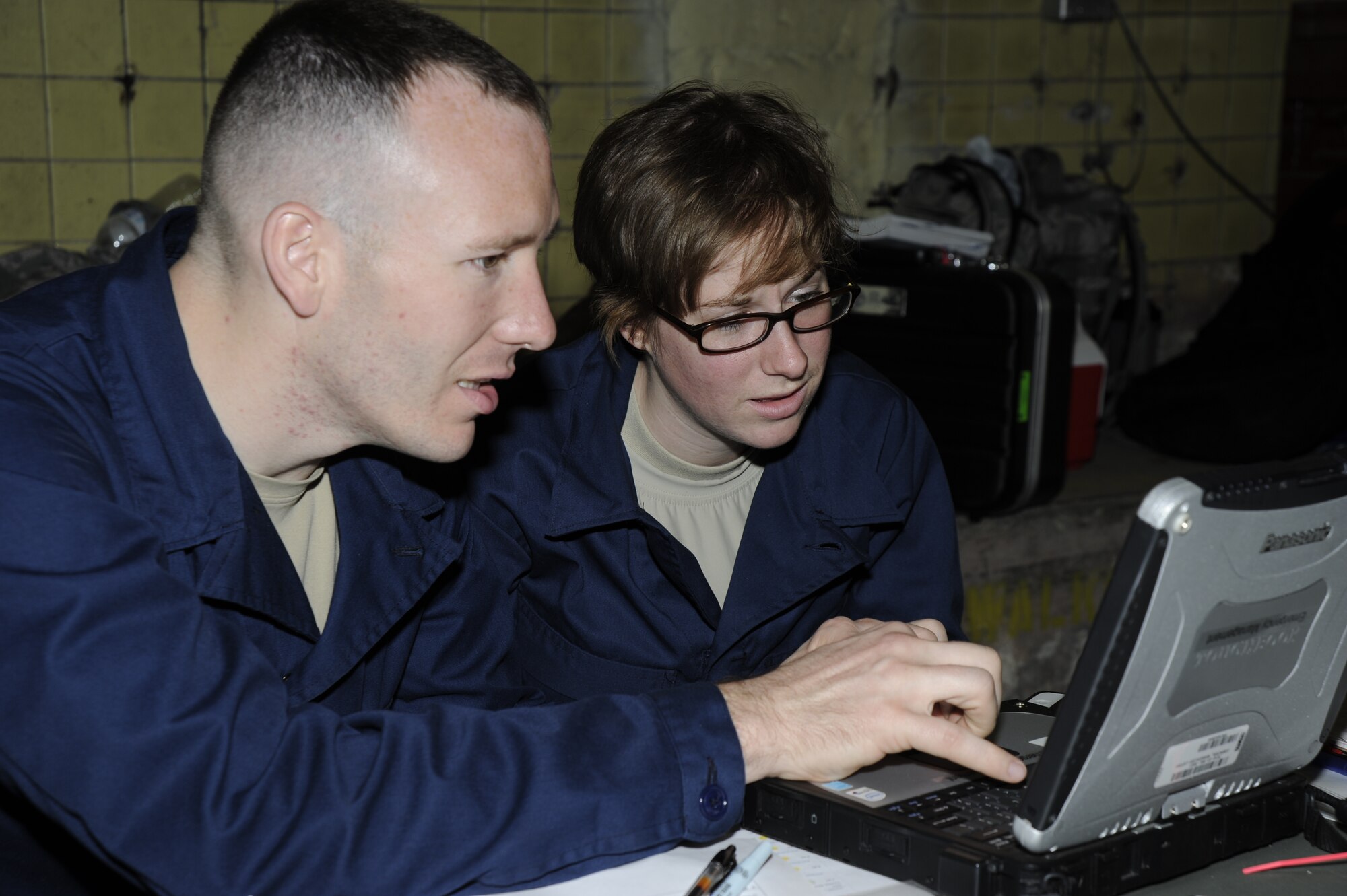 Senior Airman Eric Reist and Airman 1st Class Molly Clune, 11th Civil Engineer Squadron Readiness and Emergency Management, interpret results from radiological equipment March 27 during the Air Force District of Washington Black Flag Exercise held at the Center for National Response in Gallagher W.Va. Airmen from the 11th Civil Engineering Squadron and 779th Aerospace Medical Squadron, Joint Base Andrews, Md.; and the 579th Medical Operations Squadron, Joint Base Anacostia-Bolling, Washington D.C. came together for the joint training exercise. (U.S. Air Force photo by Staff Sgt. Christopher Ruano)