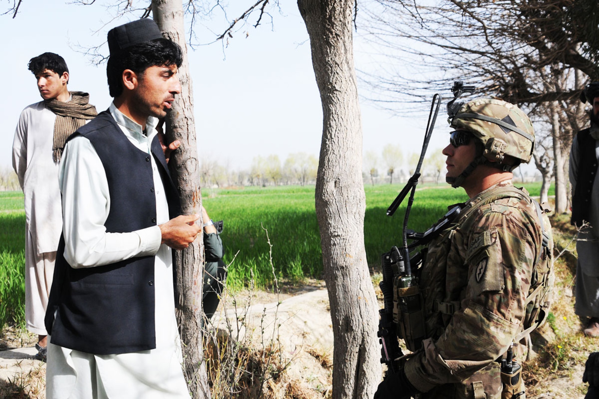 Sgt. Christopher Alford, a team leader with 1st Platoon, Comanche Company, Task Force Blue Geronimo, from Greenwood, Ind., speaks with a local villager. (U.S. Army photo/Spc. Erik-James Estrada)
