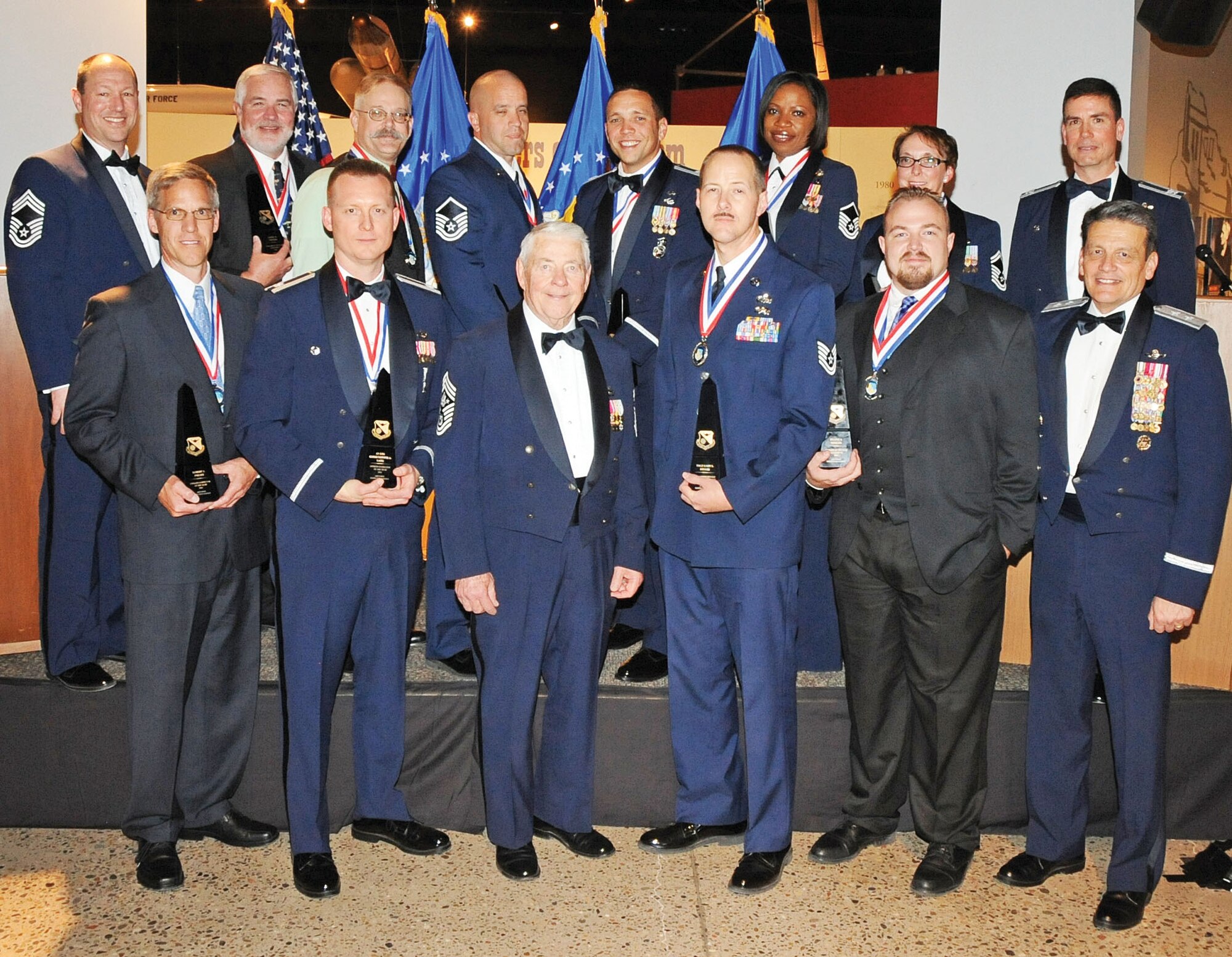 KIRTLAND AFB, N.M. – The Air Force Inspection Agency recognized annual award recipients March 23 at the National Museum of Nuclear Science and History. Pictured, in the back row, from left: Chief Master Sgt. David Marchant, AFIA chief enlisted manager; Larry Dreyer, civilian of the year, category V; David Wheelock, civilian of the year, category II; Master Sgt. James Spino, senior NCO of the year; Capt. Jesse Goens, company grade officer of the year; Master Sgt. Antoine Culbreath, inspector of the year, enlisted category; Senior Master Sgt. Rene Dixon, Commander’s Leadership Award; and Col. Paul Tibbets, AFIA commander. Front row, from left: Sam Pyeatt, inspector of the year, civilian category; Lt. Col. Christopher Lane, inspector of the year, officer category; Chief Master Sgt. of the Air Force No. 5 Robert D. Gaylor, Tech. Sgt. Gary Keller, NCO of the year; Duane Martin, civilian of the year, category III; and Maj. Gen. Frank J. Padilla, Air Force Deputy Inspector General. Not pictured are Jerry W. Rose, civilian of the year, category IV; Maj. Clinos (Mike) Jackson, field grade officer of the year; and Valerie Lindsey, innovator of the year.  (Photo by Dennis Carlson)