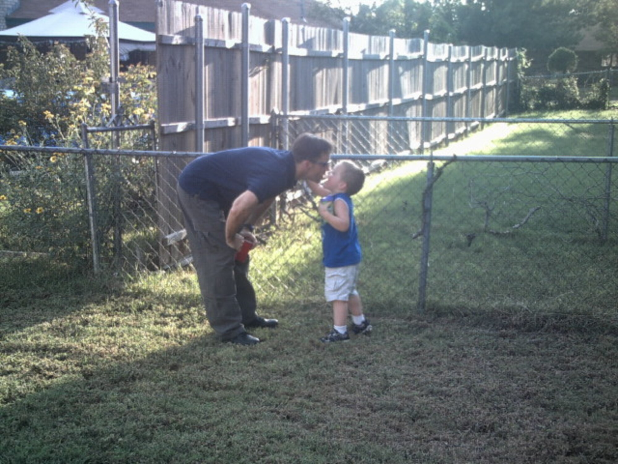Staff Sgt. Sean McLain, a maintenance instructor with the 363rd Training Squadron at Sheppard Air Force Base, at a family barbecue with his son Dylan, who has autism in this undated photo.  McLain and his family are one of the many Air Force families who have benefitted from the assistance of the revamped Exceptional Family Member Program.  (U.S. Air Force courtesy photo)