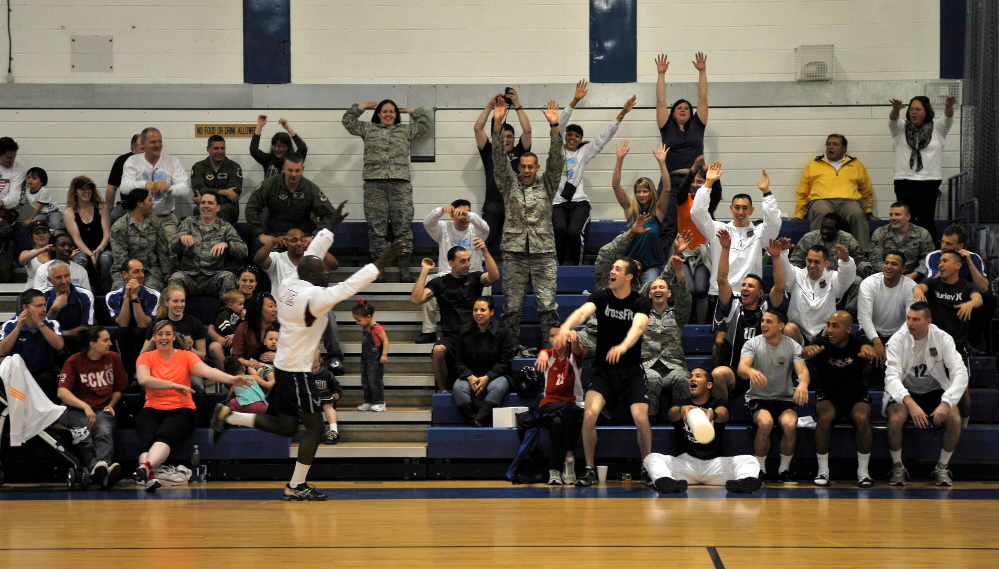 ROYAL AIR FORCE LAKENHEATH, England -- Staff Sgt. Thomas Spencer, Ramstein Air Base Germany, U.S. Air Forces in Europe men's team, gets the crowd into the game by performing a wave during the Headquarters Allied Air Component Ramstein Volleyball Championship Tournament at the RAF Lakenheath Fitness Center March 28, 2012.  The aim of the tournament is to encourage and assist the promotion of inter-nation sporting activities among NATO Allied Air Command teams.  The U.S. men's team won third place in the competition.  (U.S. Air Force photo by Staff Sgt. Connor Estes)