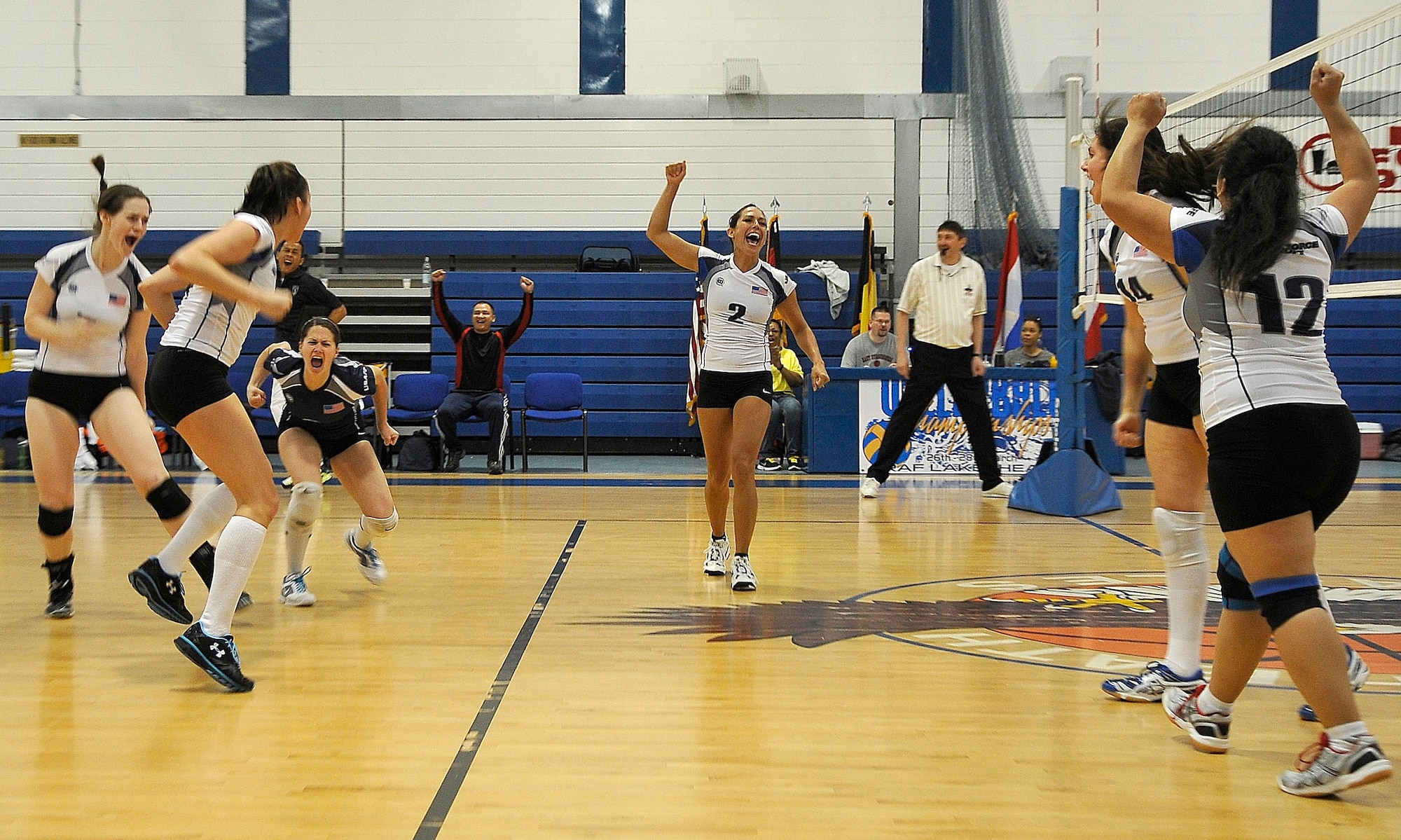ROYAL AIR FORCE LAKENHEATH, England -- The U.S. Air Forces in Europe women's volleyball team celebrate after scoring a point against the German Air Force team during the Headquarters Allied Air Component Ramstein Volleyball Championship Tournament at the RAF Lakenheath Fitness Center March 28, 2012.  The aim of the tournament is to encourage and assist the promotion of inter-nation sporting activities among NATO Allied Air Command teams.  The U.S. women's team won first place in the competition.  (U.S. Air Force photo by Staff Sgt. Connor Estes)