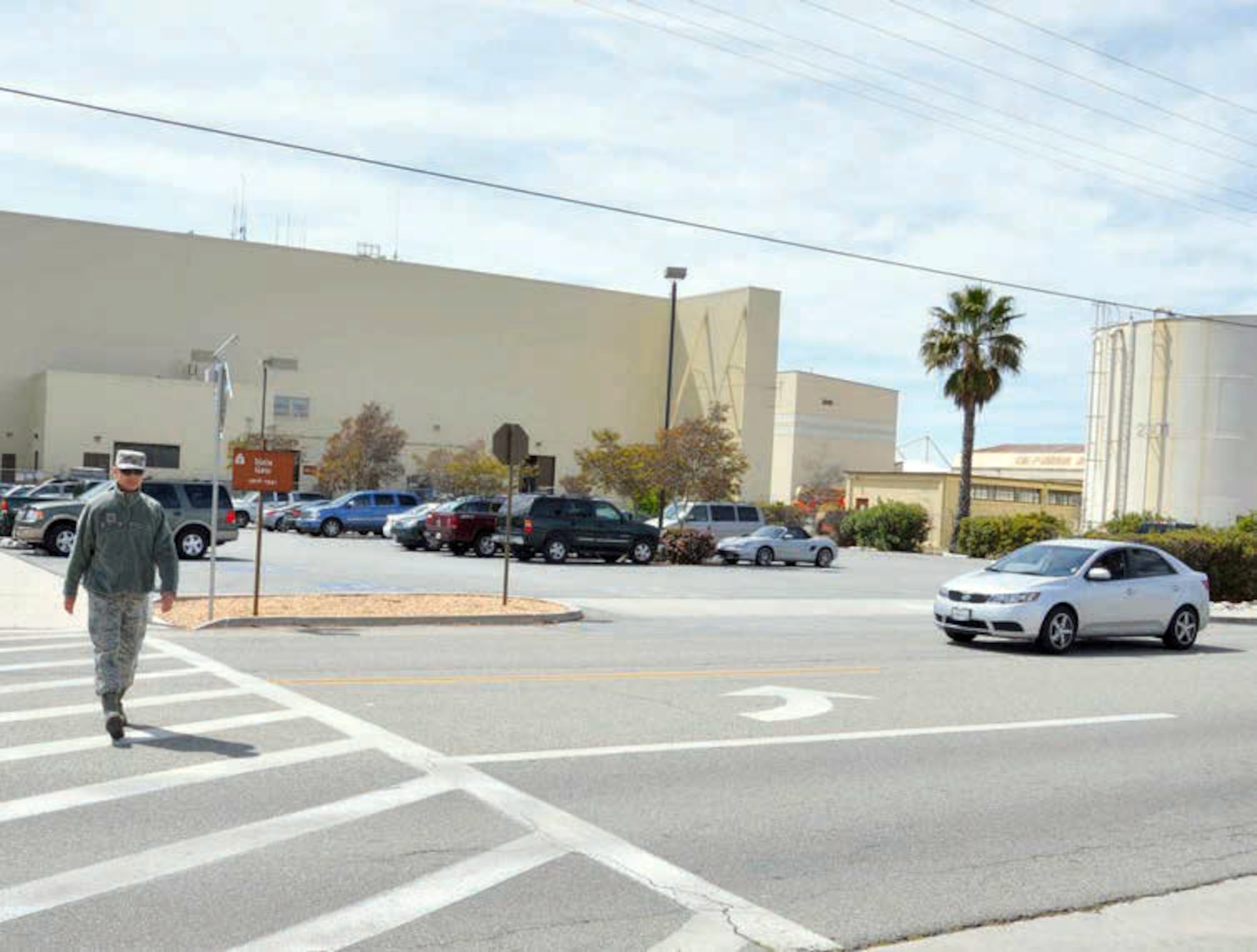 Staff Sgt. Neil Ballacer, 163 Reconnaissance Wing public affairs, uses a crosswalk
on base for safe passage to the other side of the street. Vehicles are reminded
to yield until pedestrians have safely cleared the crosswalk. (U.S. Air Force photo / Lt. Col. Don Traud)