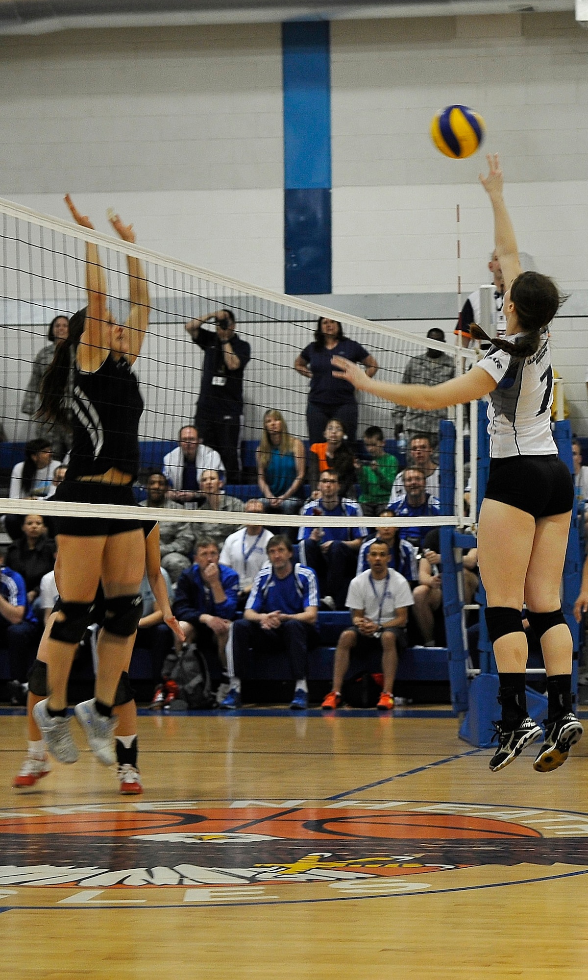 ROYAL AIR FORCE LAKENHEATH, England -- Senior Airman Meghan Haas, Aviano Air Base Italy, U.S. Air Forces in Europe women's team, tips the ball against the German Air Force team during the Headquarters Allied Air Component Ramstein Volleyball Championship Tournament at the RAF Lakenheath Fitness Center March 28, 2012.  The aim of the tournament is to encourage and assist the promotion of inter-nation sporting activities among NATO Allied Air Command teams.  The U.S. women's team won first place in the competition.  (U.S. Air Force photo by Staff Sgt. Connor Estes)