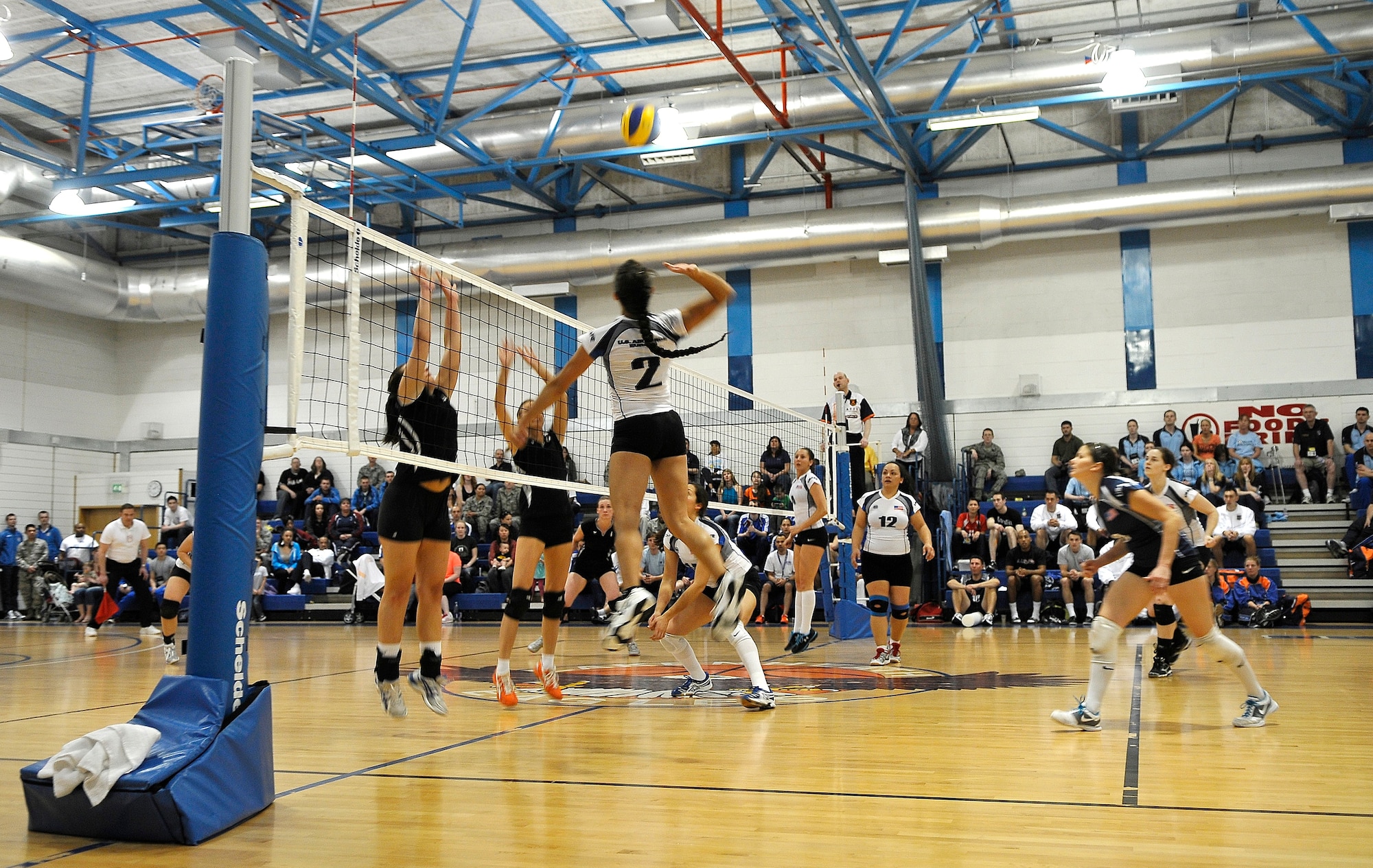 ROYAL AIR FORCE LAKENHEATH, England -- Maj. Ana-Maria Ortega, Ramstein Air Base Germany, U.S. Air Forces in Europe women's team, spikes the ball against the German Air Force team during the Headquarters Allied Air Component Ramstein Volleyball Championship Tournament at the RAF Lakenheath Fitness Center March 28, 2012.  The aim of the tournament is to encourage and assist the promotion of inter-nation sporting activities among NATO Allied Air Command teams.  The U.S. women's team won first place in the competition.  (U.S. Air Force photo by Staff Sgt. Connor Estes)