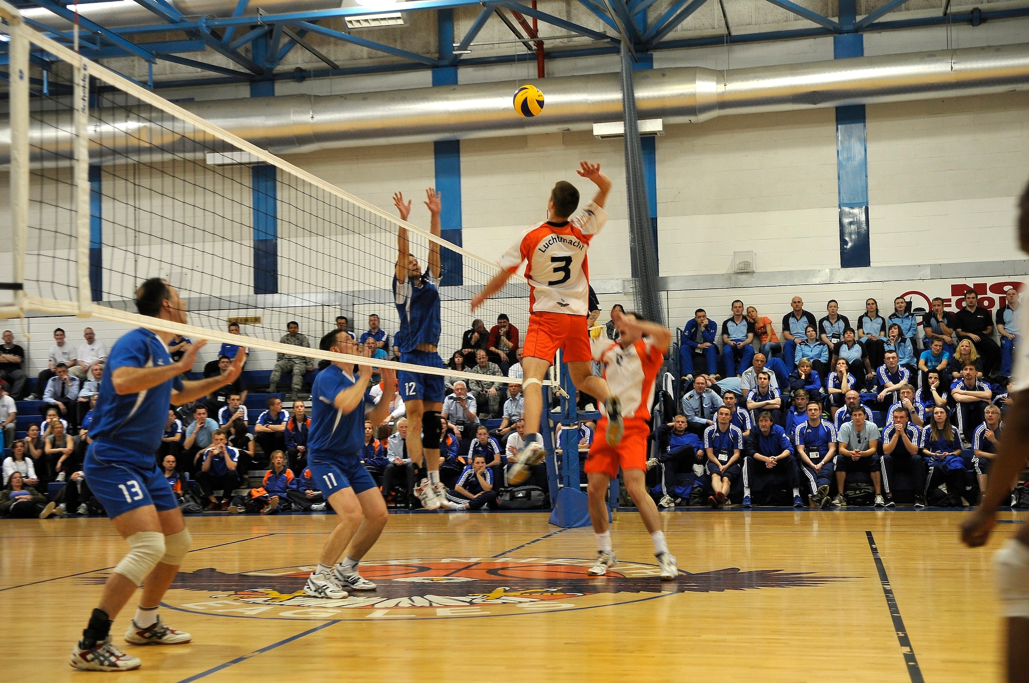 ROYAL AIR FORCE LAKENHEATH, England -- Corporal 1st Class Cas Vrede, Royal Netherlands Air Force, spikes the ball against the Polish Air Force during the Headquarters Allied Air Component Ramstein Volleyball Championship Tournament at the RAF Lakenheath Fitness Center March 28, 2012.  The aim of the tournament is to encourage and assist the promotion of inter-nation sporting activities among NATO Allied Air Command teams.  The Netherlands men's team won first place in the competition.  (U.S. Air Force photo by Staff Sgt. Connor Estes)