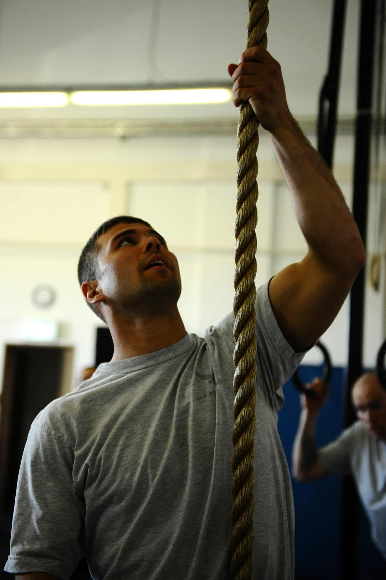 SPANGDAHLEM AIR BASE, Germany – Airman 1st Class Andrew Herget, 52nd Civil Engineer Squadron, prepares to climb a rope during the Iron Flight Competition at the Combat Fitness Center here March 28. The quarterly competition is an incentive program intended to build comraderie and test the mental and physical endurance of the participating squadron members. Four teams participated in the six-person team competition that consisted of three different events. The 52nd Equipment Maintenance Squadron ammo team won the competition after a three-way tie-breaker rope-climbing event against the 52nd Civil Engineer Squadron and the 52nd Component Maintenace Squadron. (U.S. Air Force photo by Airman 1st Class Matthew B. Fredericks/Released)