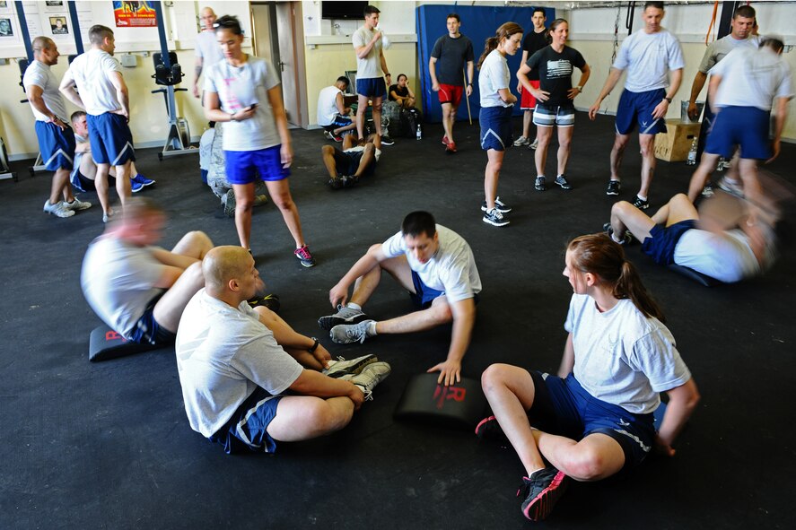 SPANGDAHLEM AIR BASE, Germany – Airmen from the 52nd Civil Engineer Squadron, 52nd Component Maintenance Squadron and the 52nd Equipment Maintenance Squadron perform situps during the Iron Flight Competition at the Combat Fitness Center here March 28. The quarterly competition is an incentive program intended to build comraderie and test the mental and physical endurance of the participating squadron members. Four teams participated in the six-person team competition that consisted of three different events. The 52nd Equipment Maintenance Squadron ammo team won the competition after a three-way tie-breaker rope-climbing event against the 52nd Civil Engineer Squadron and CMS. (U.S. Air Force photo by Airman 1st Class Matthew B. Fredericks/Released)