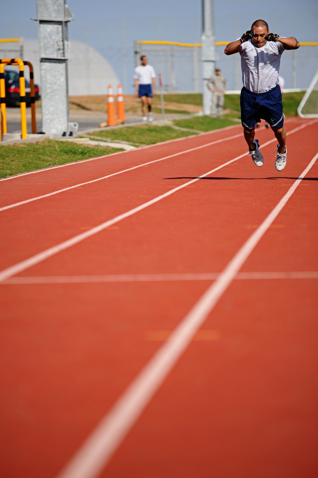 SPANGDAHLEM AIR BASE, Germany – Master Sgt. Jerry Torrez, 52nd Equipment Maintenance Squadron, performs a long jump during a relay for the Iron Flight Competition at the track here March 28. The quarterly competition is an incentive program intended to build comraderie and test the mental and physical endurance of the participating squadron members. Four teams participated in the six-person team competition that consisted of three different events. The 52nd Equipment Maintenance Squadron ammo team won the competition after a three-way tie-breaker rope-climbing event against the 52nd Civil Engineer Squadron and the 52nd Component Maintenance Squadron. (U.S. Air Force photo by Airman 1st Class Matthew B. Fredericks/Released)