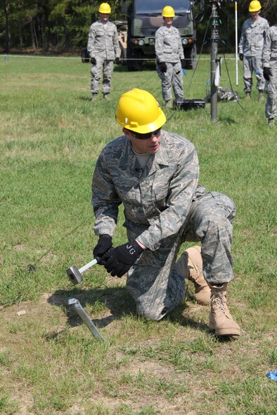 Reynolds Wolf, CNN meteorologist and correspondent, sets up a guy wire support stake for a 51st Combat Communications Squadron land mobile radio repeater antenna mast here March 28. A three-person CNN team visited the 689th Combat Communications Wing to experience what it is like to be a combat communications Airman for the day.  Combat Comm provided hands-on experiences that showcased the physical, technical, and mental readiness of Combat Communicators.  (U.S. Air Force photo by Robert Talenti)