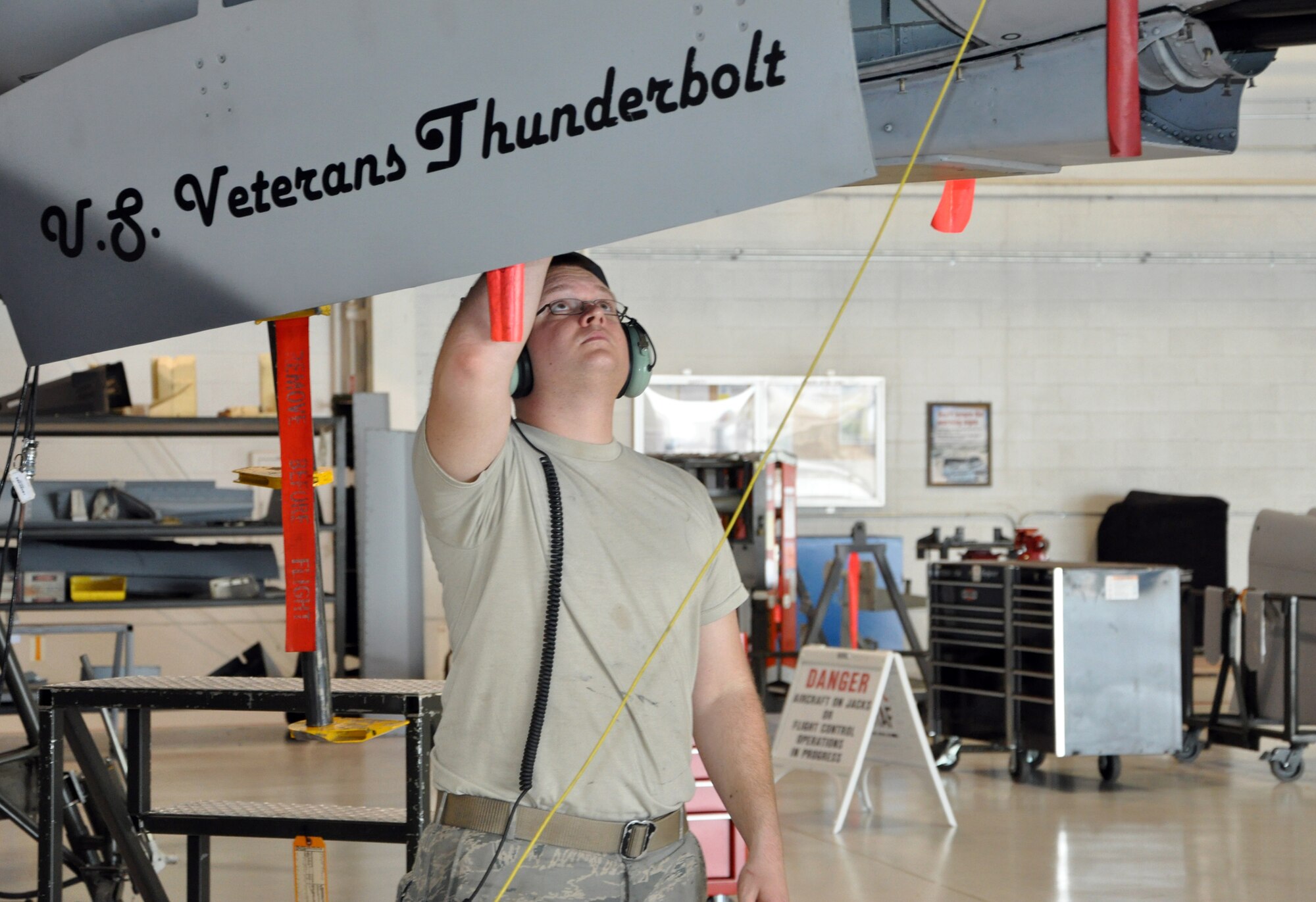 Staff Sgt. Brandon Cole, 442nd Maintenance Squadron Armament Flight technician, attaches a remove-before-flight-ribbon to an A-10 Thunderbolt II as part of the regular phase inspection cycle, March 27, 2012. The 442nd MXS is part of the 442nd Fighter Wing, an A-10 Air Force Reserve unit at Whiteman Air Force Base, Mo. (U.S. Air Force Photo/Senior Airman Wesley Wright)