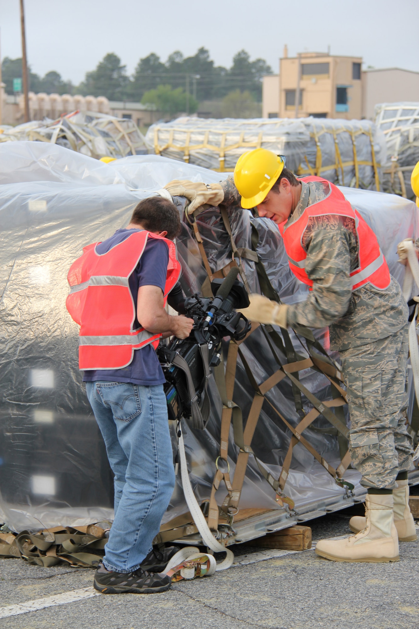 Ferre Dollar, CNN photographer, captures Reynolds Wolf, CNN meteorologist and correspondent, building a 52nd Combat Communications Squadron equipment pallet here March 28. A three-person CNN team visited the 689th Combat Communications Wing to experience what it is like to be a combat communications Airman for the day. Combat Comm provided hands-on experiences that showcased the physical, technical, and mental readiness of Combat Communicators.  (U.S. Air Force photo by Robert Talenti)