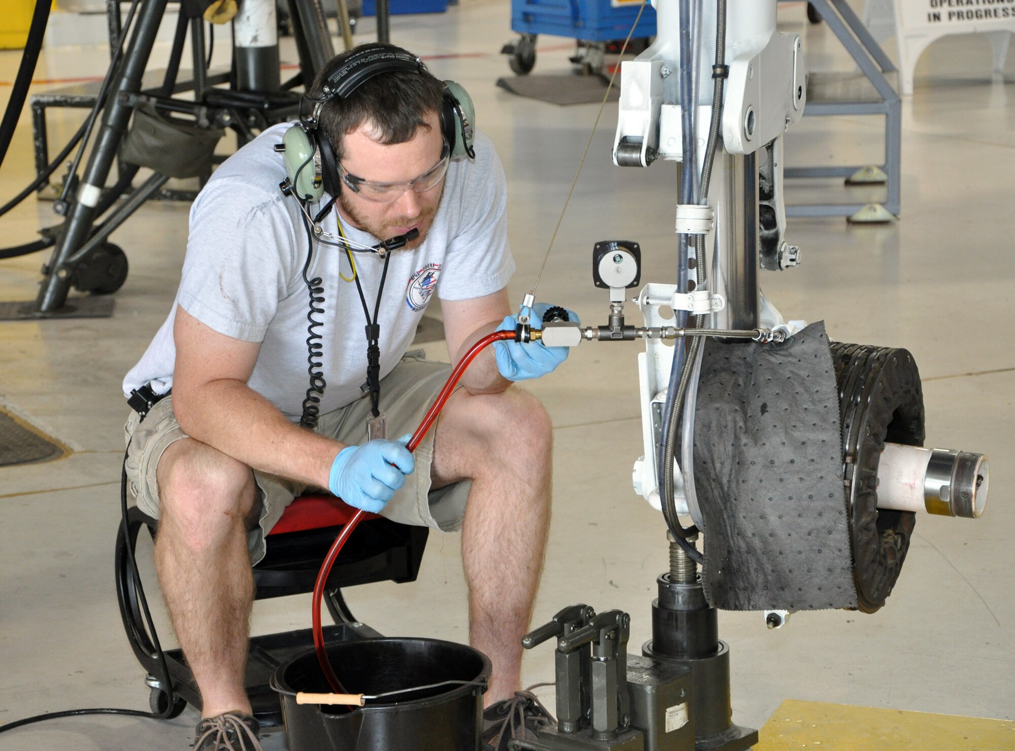 Michael Schuler, 442nd Maintenance Squadron phase dock technician, drains hydraulic fluid from the landing gear of an A-10 Thunderbolt II as part of the regular phase inspection cycle, March 27, 2012. The 442nd MXS is part of the 442nd Fighter Wing, an A-10 Air Force Reserve unit at Whiteman Air Force Base, Mo. (U.S. Air Force Photo/Senior Airman Wesley Wright)