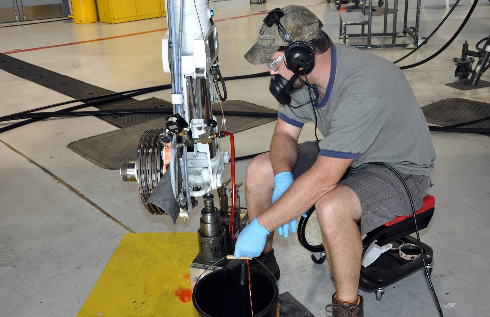 Chris Fry, 442nd Maintenance Squadron phase dock technician, drains hydraulic fluid from the landing gear of an A-10 Thunderbolt II as part of the regular phase inspection cycle, March 27, 2012. The 442nd MXS is part of the 442nd Fighter Wing, an A-10 Air Force Reserve unit at Whiteman Air Force Base, Mo. (U.S. Air Force Photo/Senior Airman Wesley Wright)