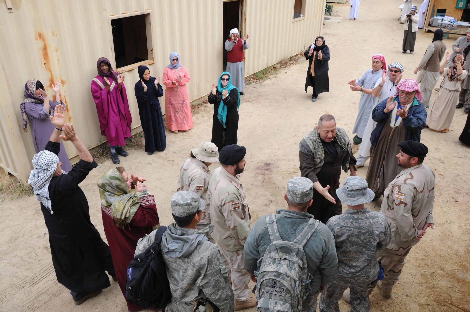 Eagle Flag participants engage with locals in the fictional village of Sabor March 21 here. The goal of Eagle Flag is to provide U.S. forces with an environment to exercise the knowledge and skills required for any type of forward operation, in any environment, regardless of mission or aircraft type. (U.S. Air Force photo by Tech. Sgt. Nathan Bevier/Released)