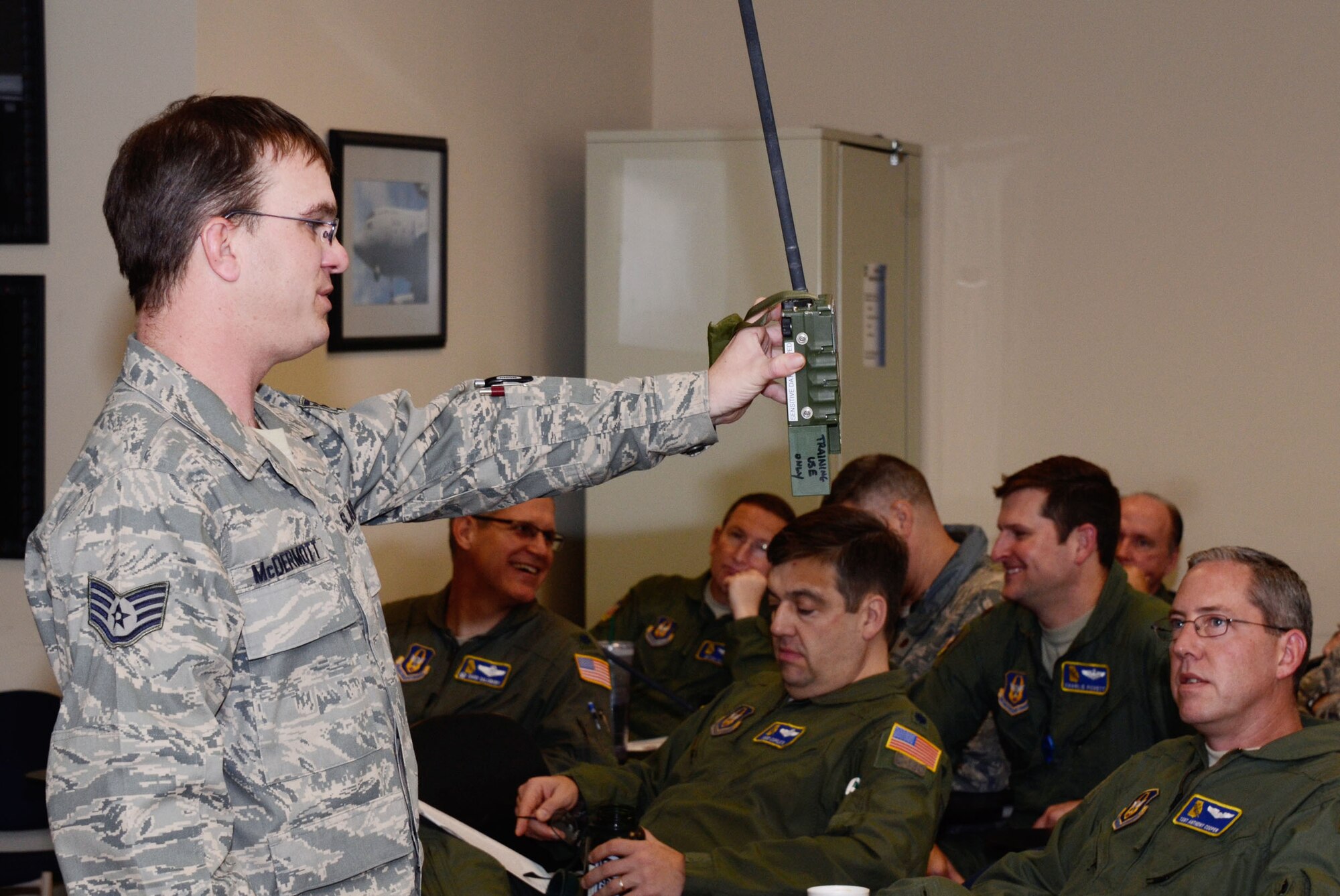 Staff Sgt. Sean R. McDermott, Aircrew Life Support, instructs members of the 700th Airlift Squadron on navigation equipment during a simulated failed engine landing Feb. 3. Members of the 700th AS and 94th Aeromedical Evacuation Squadron participated in an training exercise facilitated by the 94th Operations Support Squadron, where they evaded enemy forces in a hostile environment. (photo by Don Peek)
