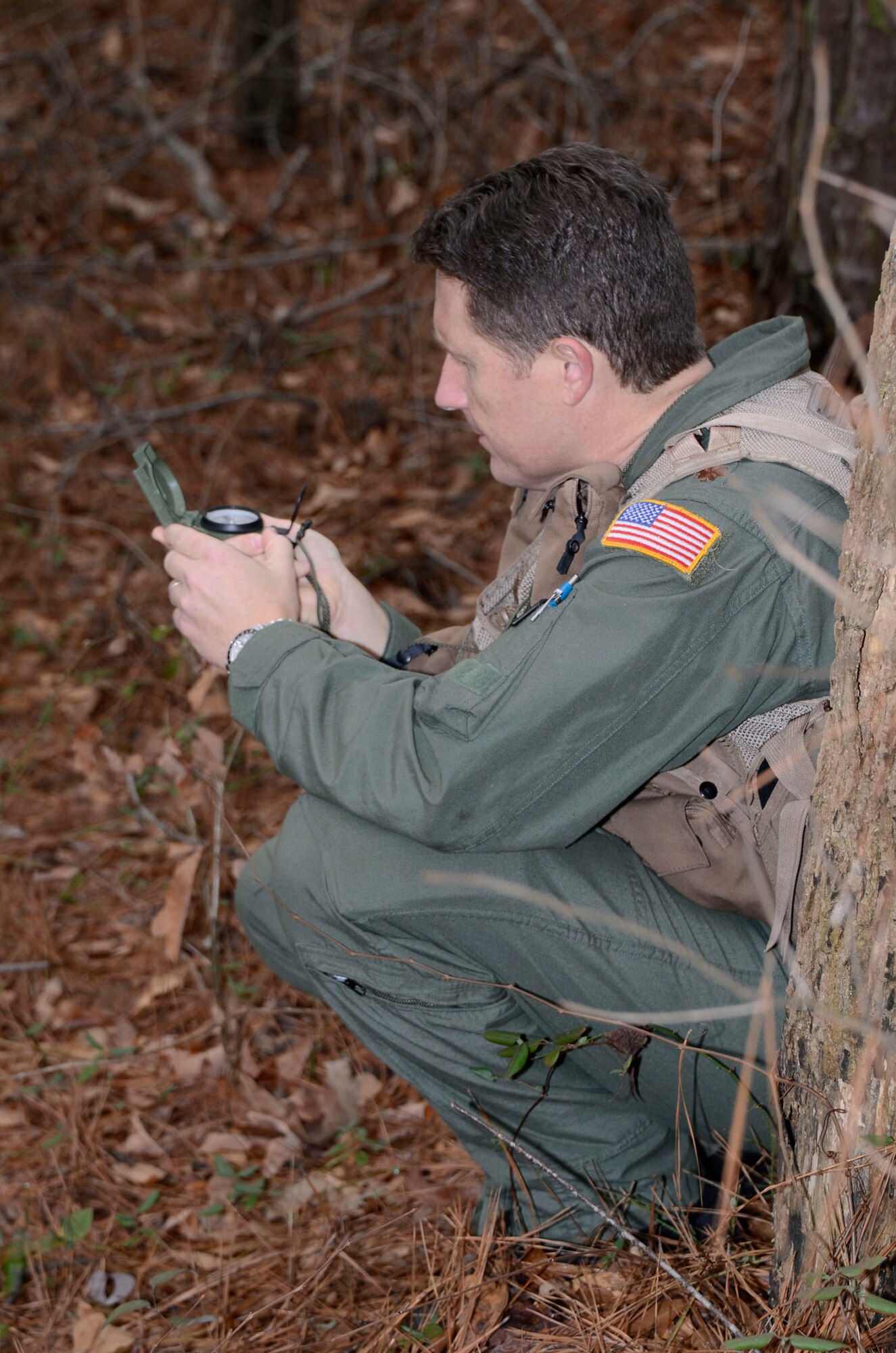 Maj. Christopher Gohlke, C-130 pilot, 700th Airlift Squadron, uses a compass to navigate to a rally point after a simulated failed engine landing Feb. 3. Members of the 700th AS and 94th Aeromedical Evacuation Squadron participated in an training exercise facilitated by the 94th Operations Support Squadron, where they evaded enemy forces in a hostile environment. (photo by Don Peek)