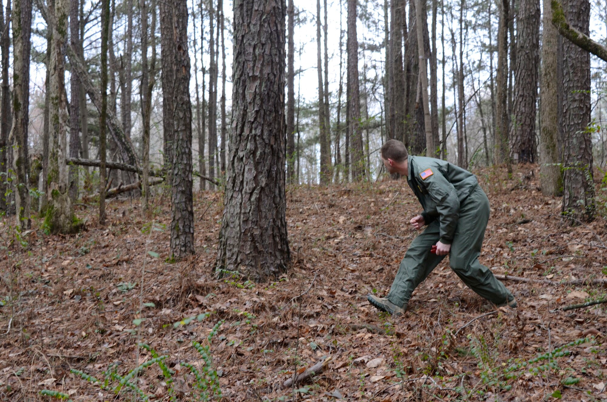 A member of the 700th Airlift Squadron, after a simulated aircraft forced landing, attempts to evade enemy forces, and by the use of a map and Global Positioning System, join his squadron members at a designated rally-point. Flyers from the 700th Airlift Squadron and the 94th Aeromedical Evacuation Squadron participated in this simulated exercise facilitated by the 94th Operations Support Squadron Feb. 3-5. The field training exercise was part of group's expeditionary combat skills training. (photo by Don Peek)