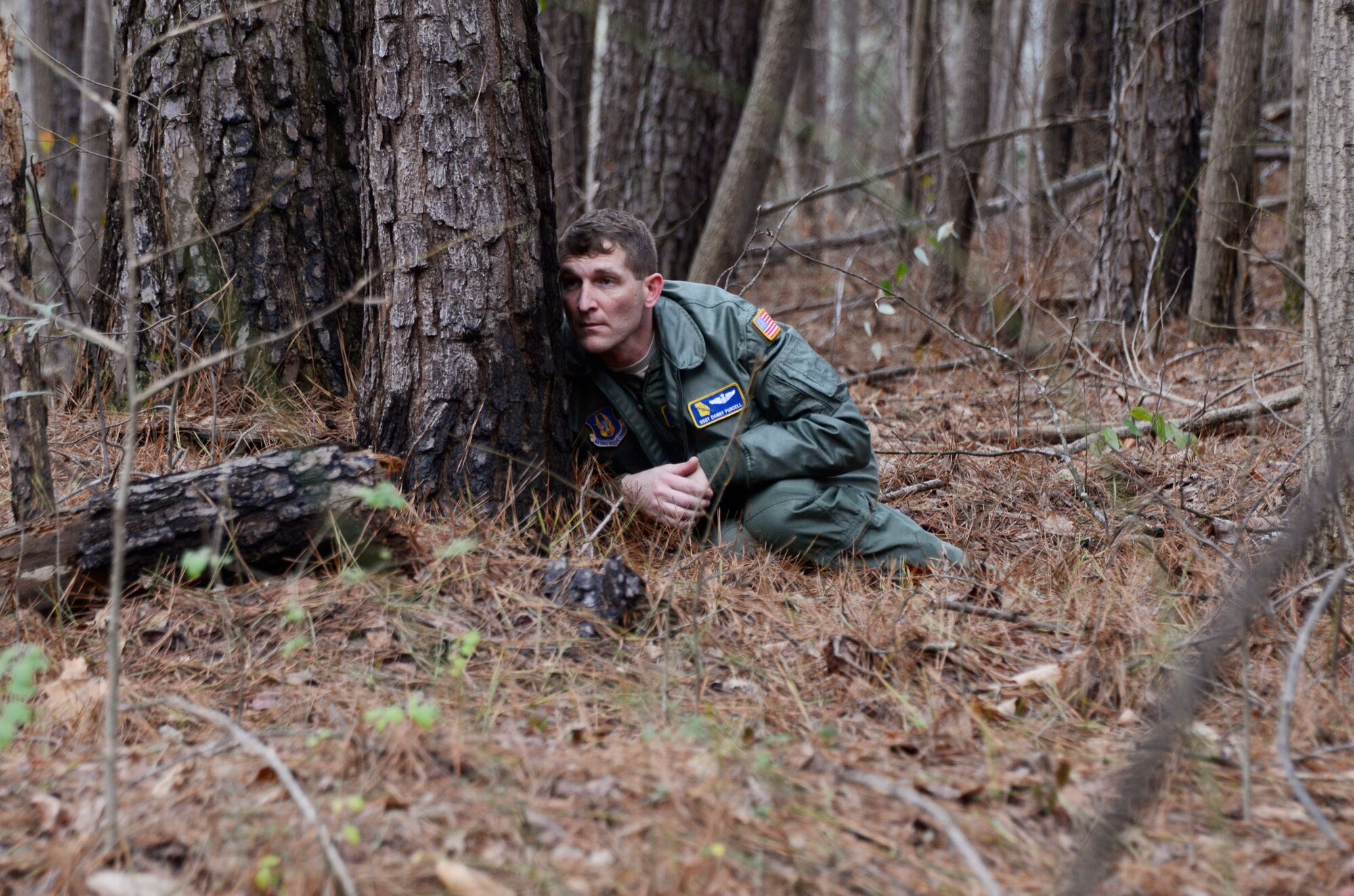 Staff Sgt. Danny Purcell, flight engineer, 700th Airlift Squadron, after a simulated aircraft forced landing, attempts to evade enemy forces, and by the use of a map and Global Positioning System, join his squadron members at a designated rally-point. Flyers from the 700th Airlift Squadron and the 94th Aeromedical Evacuation Squadron participated in this simulated exercise facilitated by the 94th Operations Support Squadron Feb. 3-5. The field training exercise was part of group's expeditionary combat skills training. (photo by Don Peek)