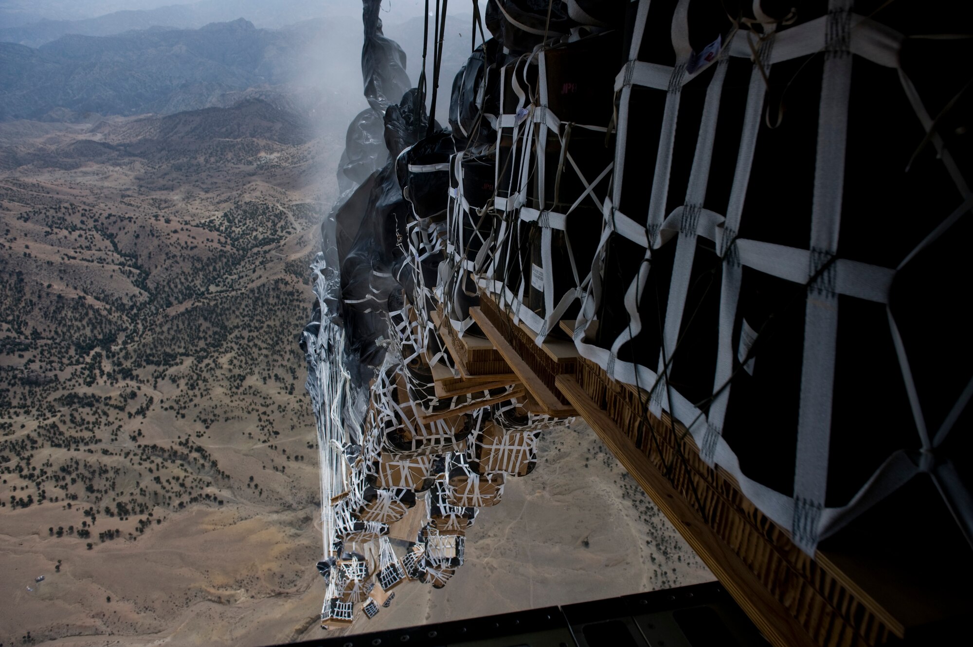 Bundles of jet fuel are delivered to an undisclosed location in Afghanistan via air drop by a C-17 Globemaster III, March 28, 2012. The C-17 is one of three aerial resupply platforms utilized by U.S. Air Forces Central's Air Mobility Division. In 2011, the AMD directed the dropping of over 58,000 bundles comprising more than 80 million pounds of critical supplies to personnel in austere combat outposts. (U.S. Air Force photo by Staff Sgt. Greg C. Biondo)