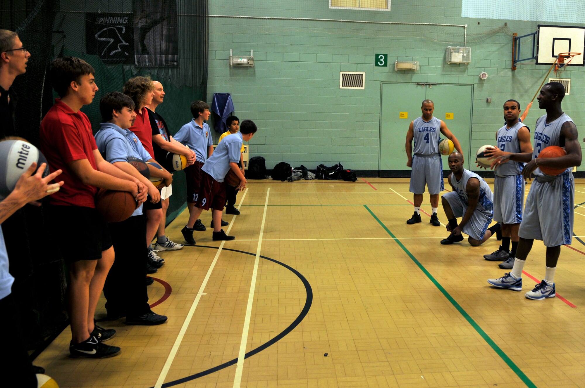 MILDENHALL, England - Players from the Royal Air Force Lakenheath Eagles varsity basketball team speak with students at the Mildenhall College of Technology March 28, 2012. The team visited the school to mentor the pupils and run basketball drills. (U.S. Air Force photo by Staff Sgt. David Dobrydney)
