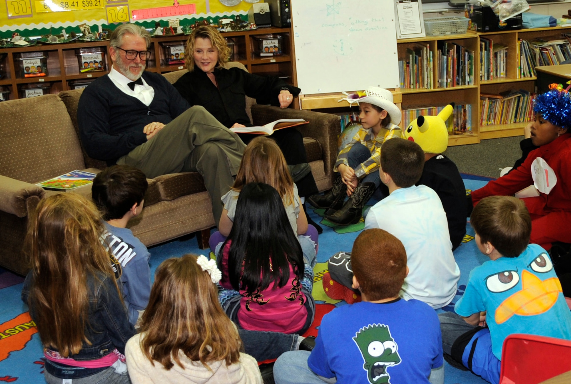 Eric Lee, Cummings Elementary School third grade teacher, and spouse Ann Lee, read to children at Cummings Elementary School during Wacky Wednesday at Misawa Air Base, Japan, March 28, 2012. Many servicemembers and civilians volunteered to read to students to promote Read Across America 2012. (U.S. Air Force photo by Airman 1st Class Kaleb Snay/Released)
