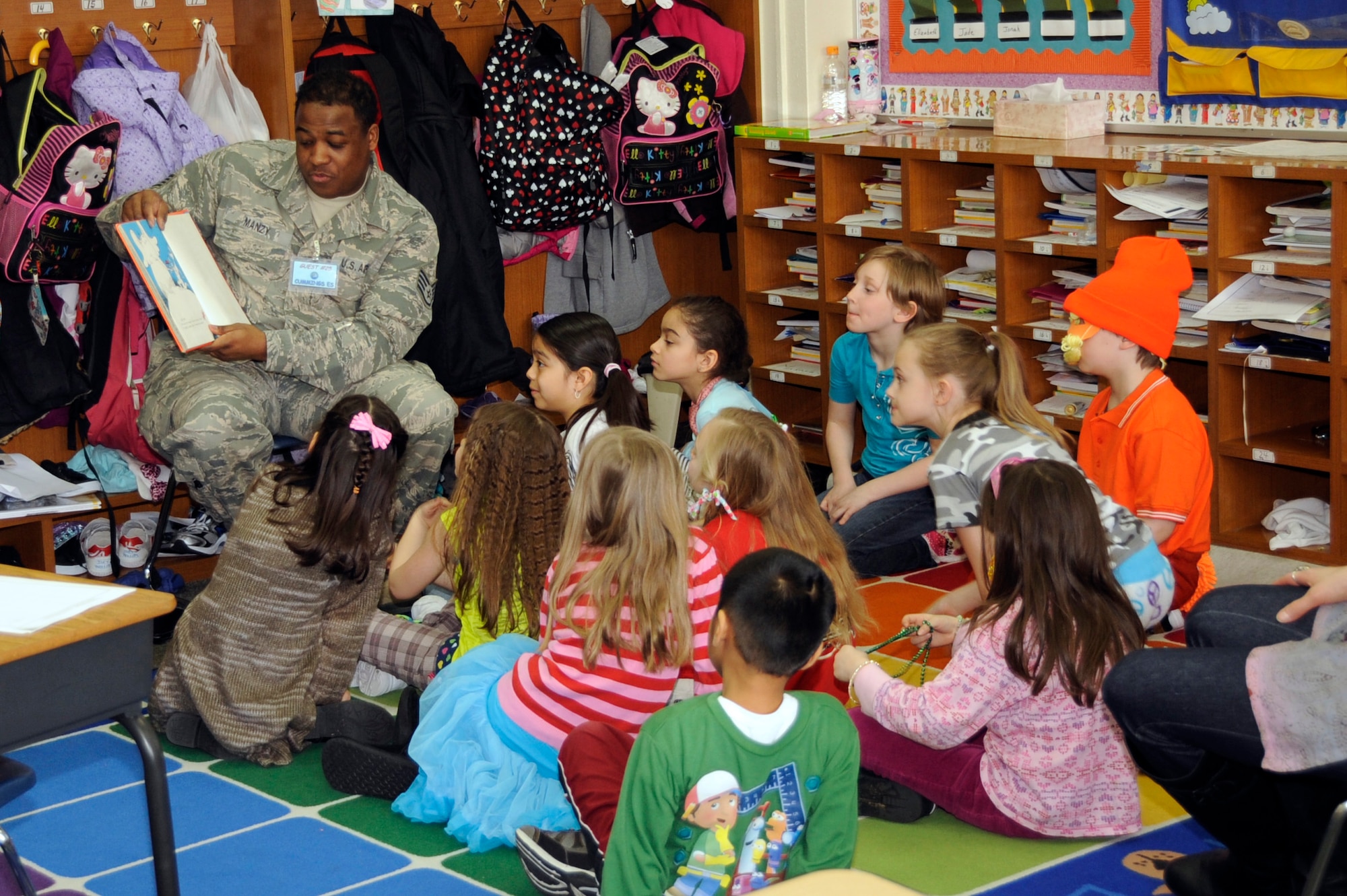 U.S. Air Force Staff Sgt. Ian Manzy, 610th Air Control Flight weapons technician, reads to children at Cummings Elementary School during Wacky Wednesday at Misawa Air Base, Japan, March 28, 2012. Wacky Wednesday is part of the school?s Read Across America 2012, which aims to promote reading to all ages. (U.S. Air Force photo by Airman 1st Class Kaleb Snay/Released)