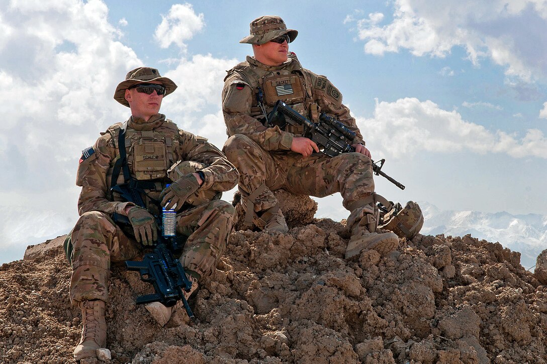 U.S. Army Spcs. Nicholas Schuch, left, and Jordan Tackett, right, wait ...