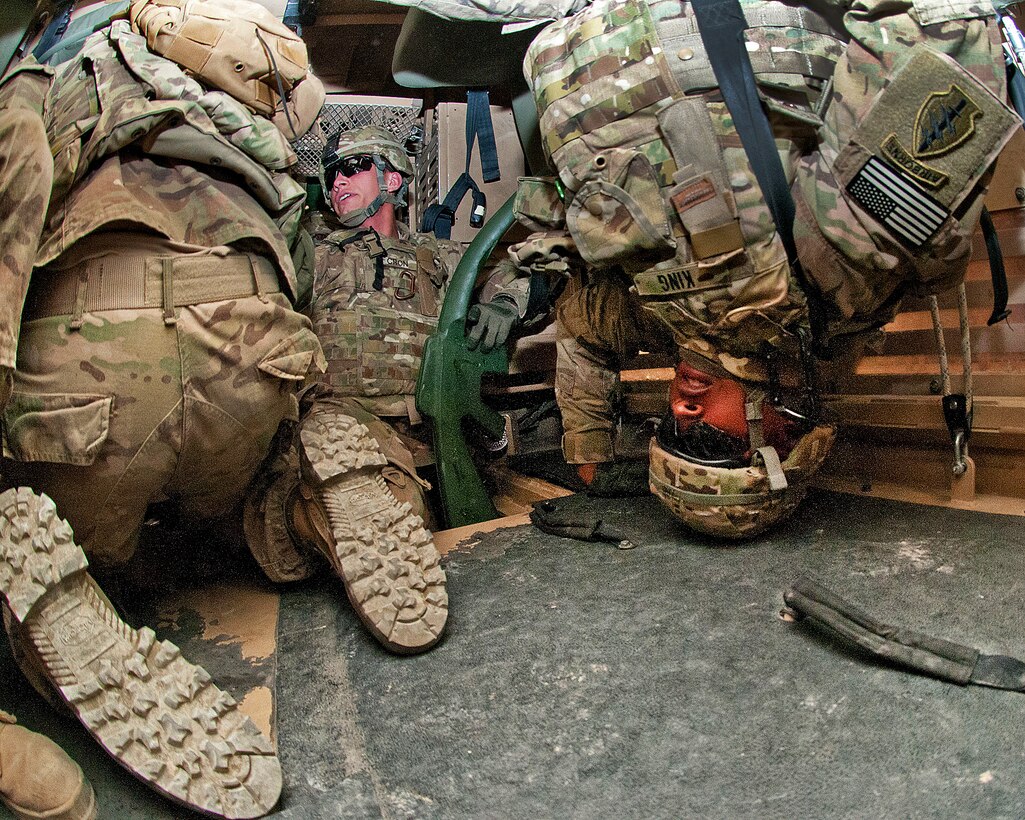 U.S. Army Chief Warrant 2 Rob King learns to free himself of his restraining harness after the vehicle simulator in which he is training flips upside down on Bagram Airfield, Afghanistan, March 26, 2012.