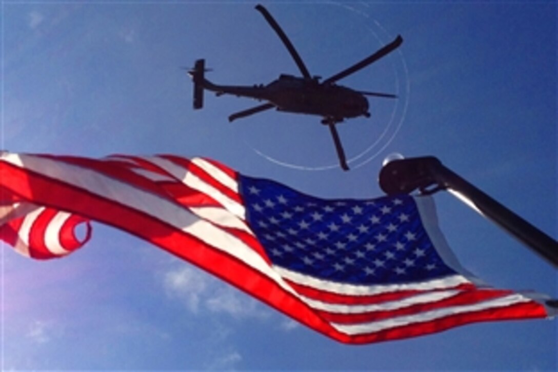 A U.S. pararescue crew hovers in an HH-60G Pave Hawk helicopter during a maritime personnel recovery exercise during an annual competition in Key West, Fla., March 20, 2012. U.S. pararescuemen and Canadian search and rescue technicians exercise together annually to synergize rescue techniques. 