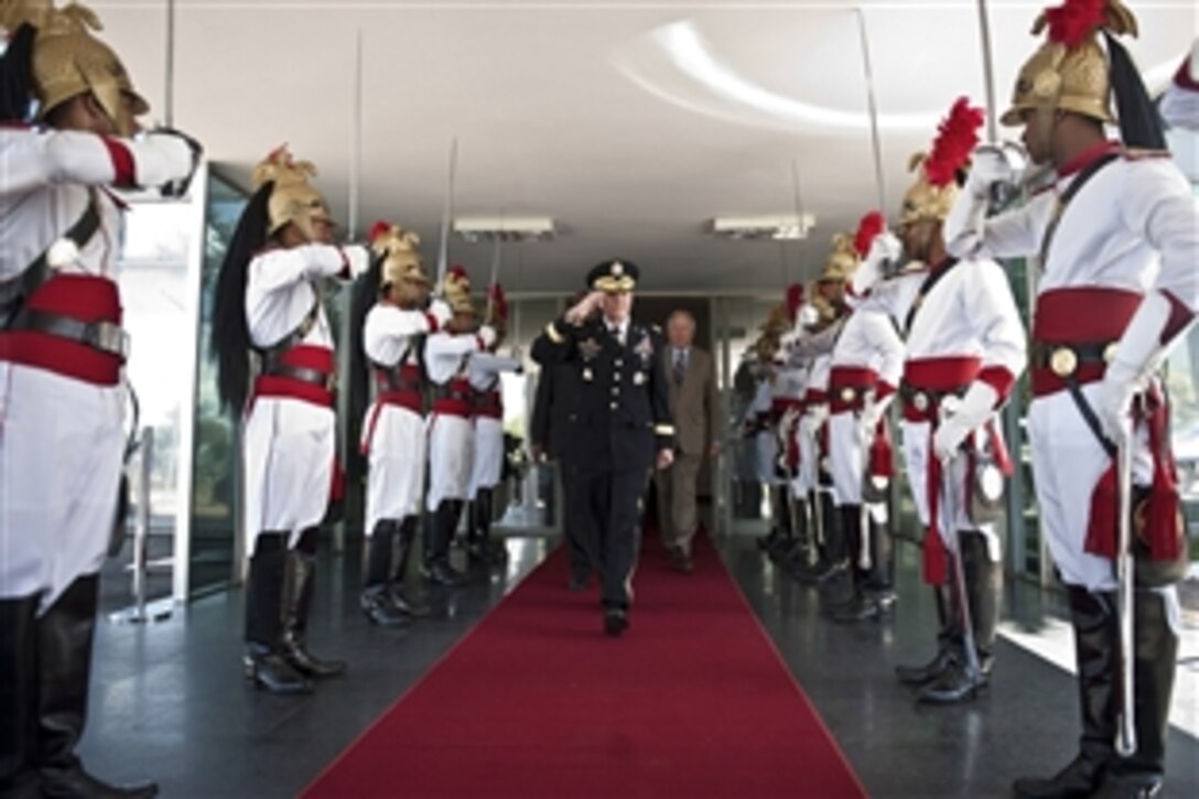 U.S. Army Gen. Martin E. Dempsey, chairman of the Joint Chiefs of Staff, salutes the honor guard after departing a meeting with U.S. and Brazilian leaders discussing their bi-lateral partnership and Brazil's role as an emerging leader in South America, March 29, 2012, in Brasilia, Brazil. 
