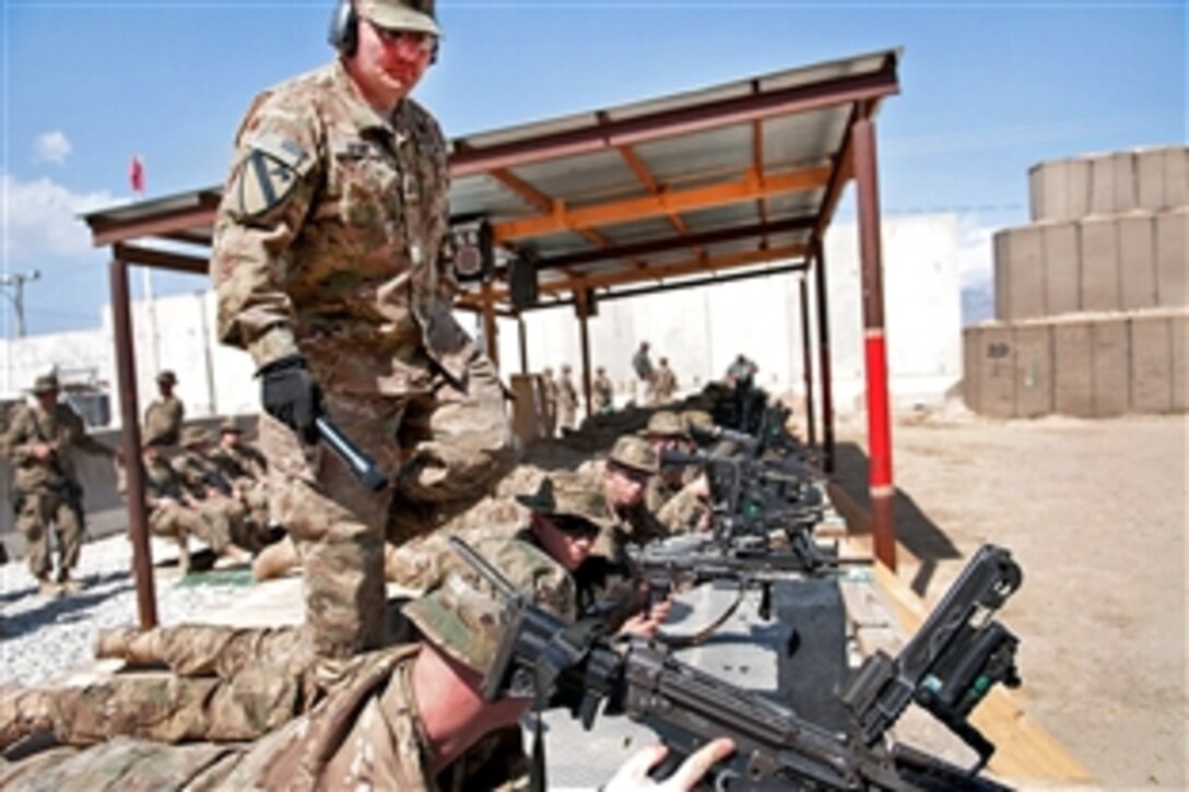 U.S. Army Sgt. 1st Class George Brace helps soldiers sight in their M249 squad automatic weapons on Bagram Air Field, Afghanistan, March 26, 2012. The soldiers must calibrate their light machine guns prior to pushing out to their forward operating bases. Brace is assigned to the 1st Cavalry Division. 