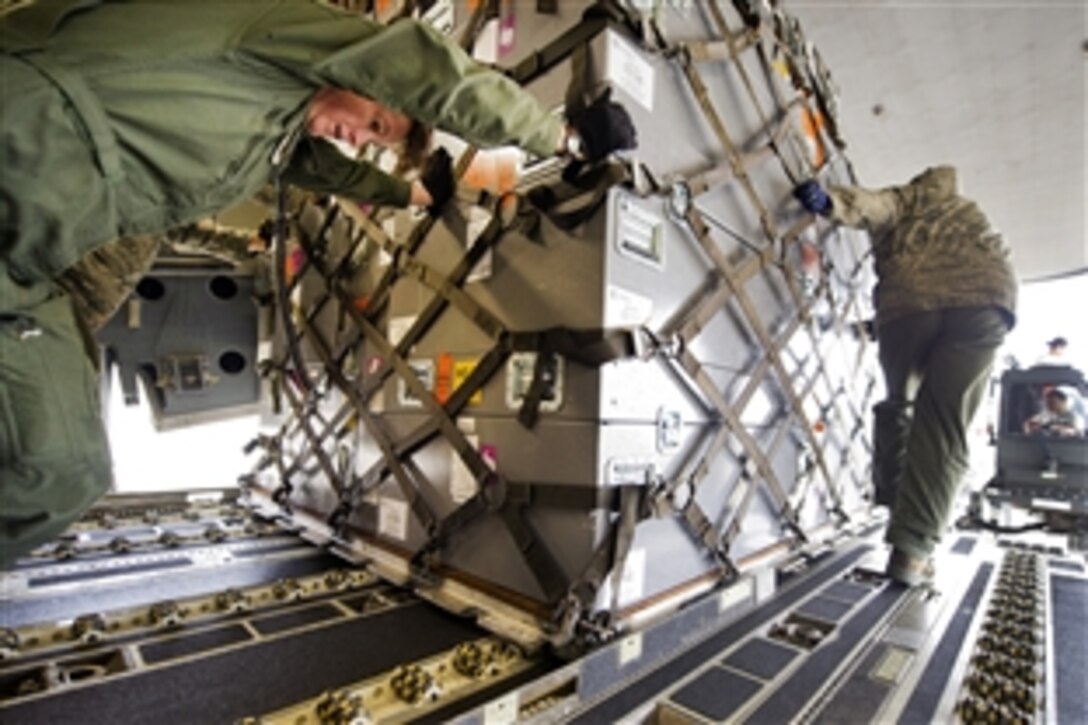 Air Force Master Sgt. Michelle Hite, left, with the 326th Airlift Squadron, helps offload cargo from a C-17 Globemaster III aircraft on Los Alamitos Army Airfield, Calif., March 17, 2012. Hite is assigned to the 326th Airlift Squadron.