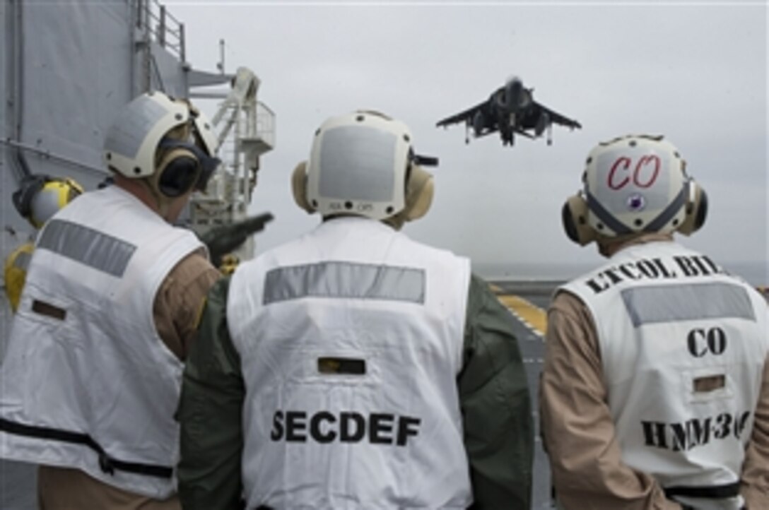 Defense Secretary Leon E. Panetta watches as an AV-8B lands on board the USS Peleliu in the Pacific Ocean off the coast of San Diego, March 30, 2012. The secretary visited several areas on board the ship as well as also viewing flight operations on deck. 