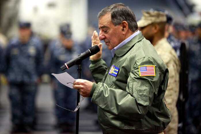 Secretary of Defense Leon Panetta reads the oath of enlistment as he reenlists several service members from the 15th Marine Expeditionary Unit and the USS Peleliu, today. During his visit, Panetta toured the ship, had lunch with Marines and sailors, pinned awards on several service members, and held a brief press conference with the media. Panetta came to visit the Marines and sailors to reinforce his commitment to maintaining an expeditionary fighting force.