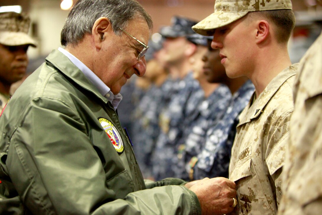 Secretary of Defense Leon Panetta pins a Navy and Marine Corps Commendation Medal on Lance Cpl. Christophe C. Cowley, an assault leader with Kilo Company, Battalion Landing Team 3/5, 15th Marine Expeditionary Unit, today. Cowley was awarded the medal for his actions in combat on 3/5’s last deployment. During his visit, Panetta toured the ship, had lunch with Marines and sailors, pinned awards on several service members, and held a brief press conference with the media. Panetta came to visit the Marines and sailors to reinforce his commitment to maintaining an expeditionary fighting force.