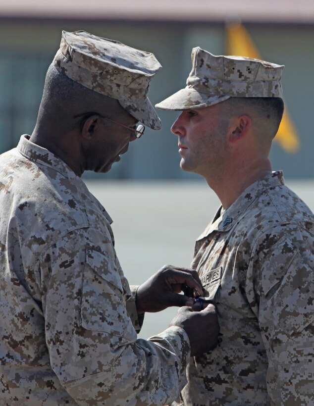 Maj. Gen. Ronald L. Bailey, commanding general, 1st Marine Division, pins the Silver Star on Sgt. Ryan T. Sotelo, Battalion Landing Team 3/5, 15th Marine Expeditionary Unit, at San Mateo, Calif., March 30. Sotelo received the award for actions he took as a squad leader with Kilo Company, 3rd Battalion, 5th Marine Regiment while deployed to Sangin District, Afghanistan.